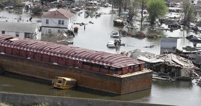A barge sits among flooded homes in New