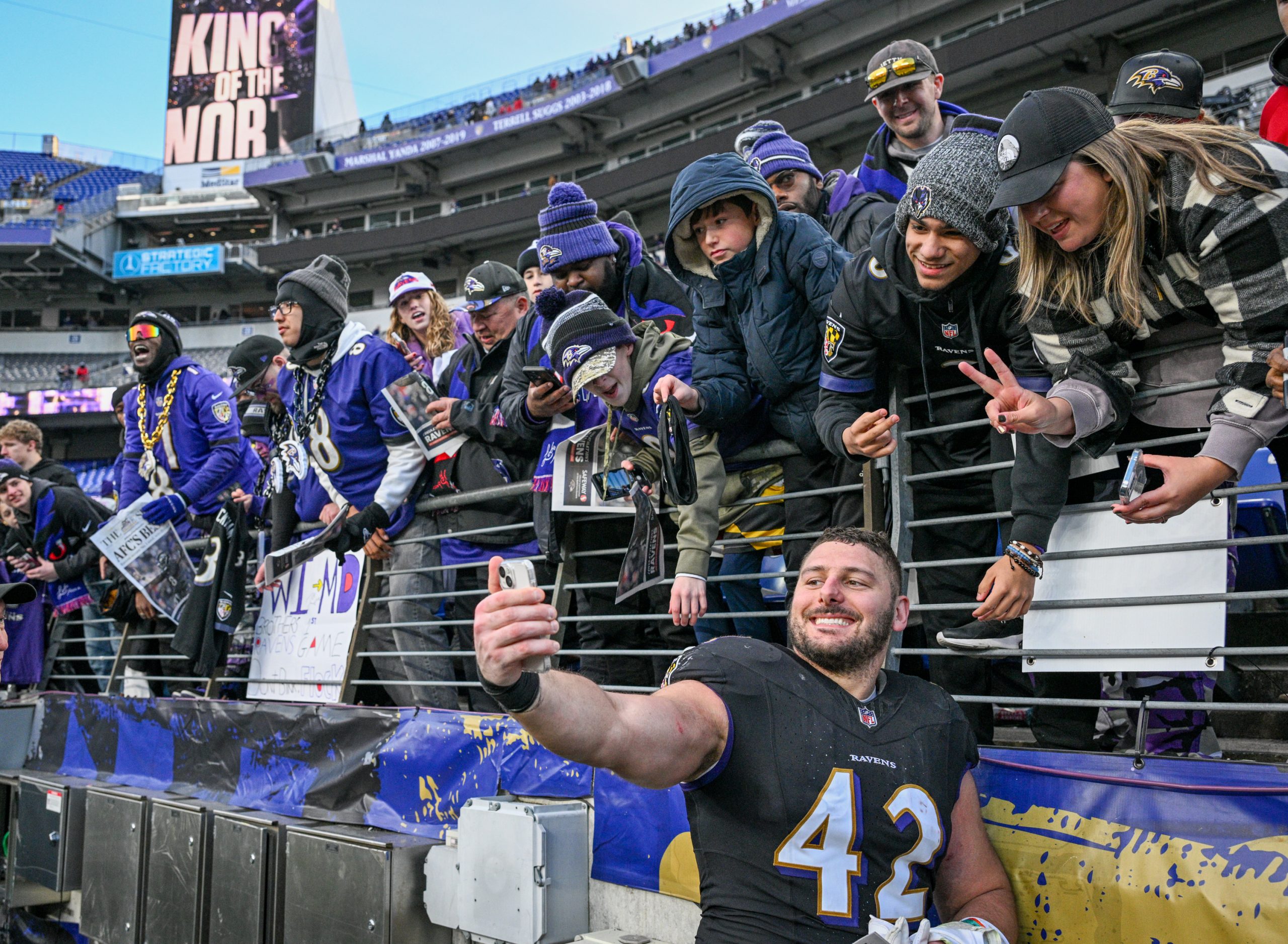Baltimore Ravens Patrick Ricard takes a selfie with fans following...