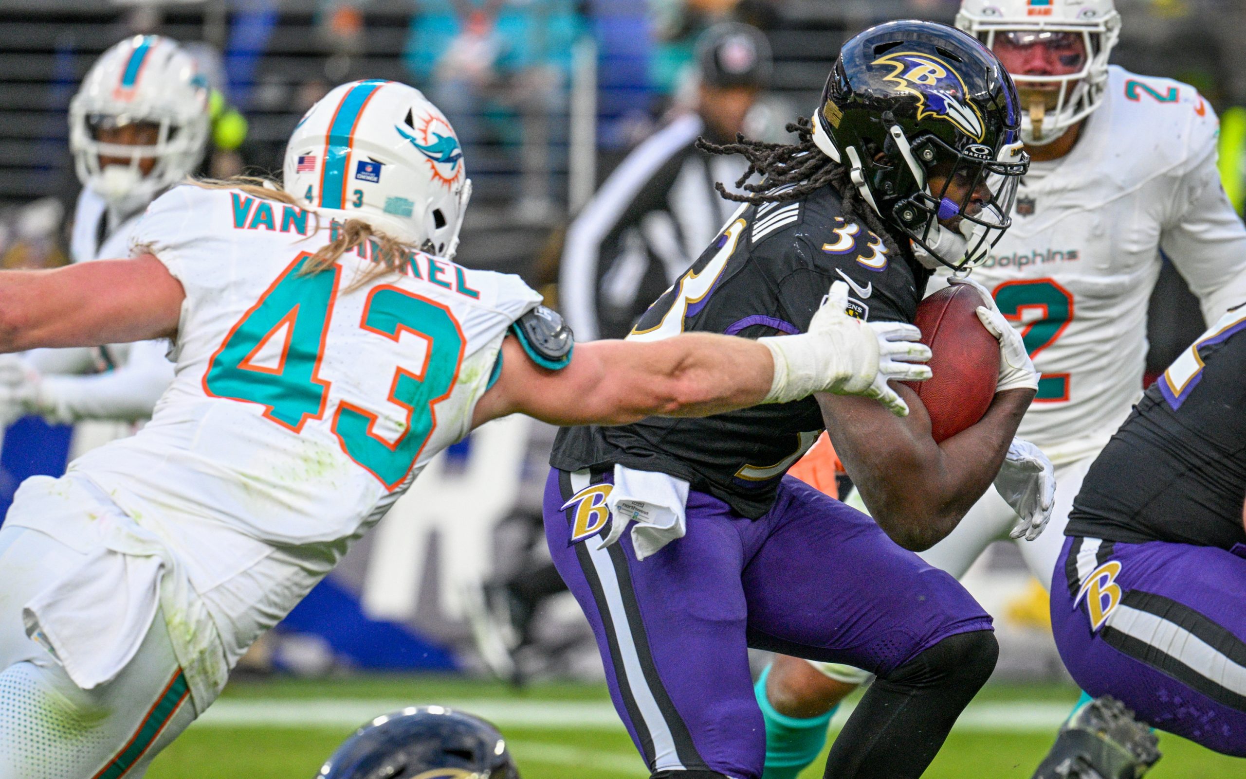Baltimore Ravens Melvin Gordon III pushes through for a gain...