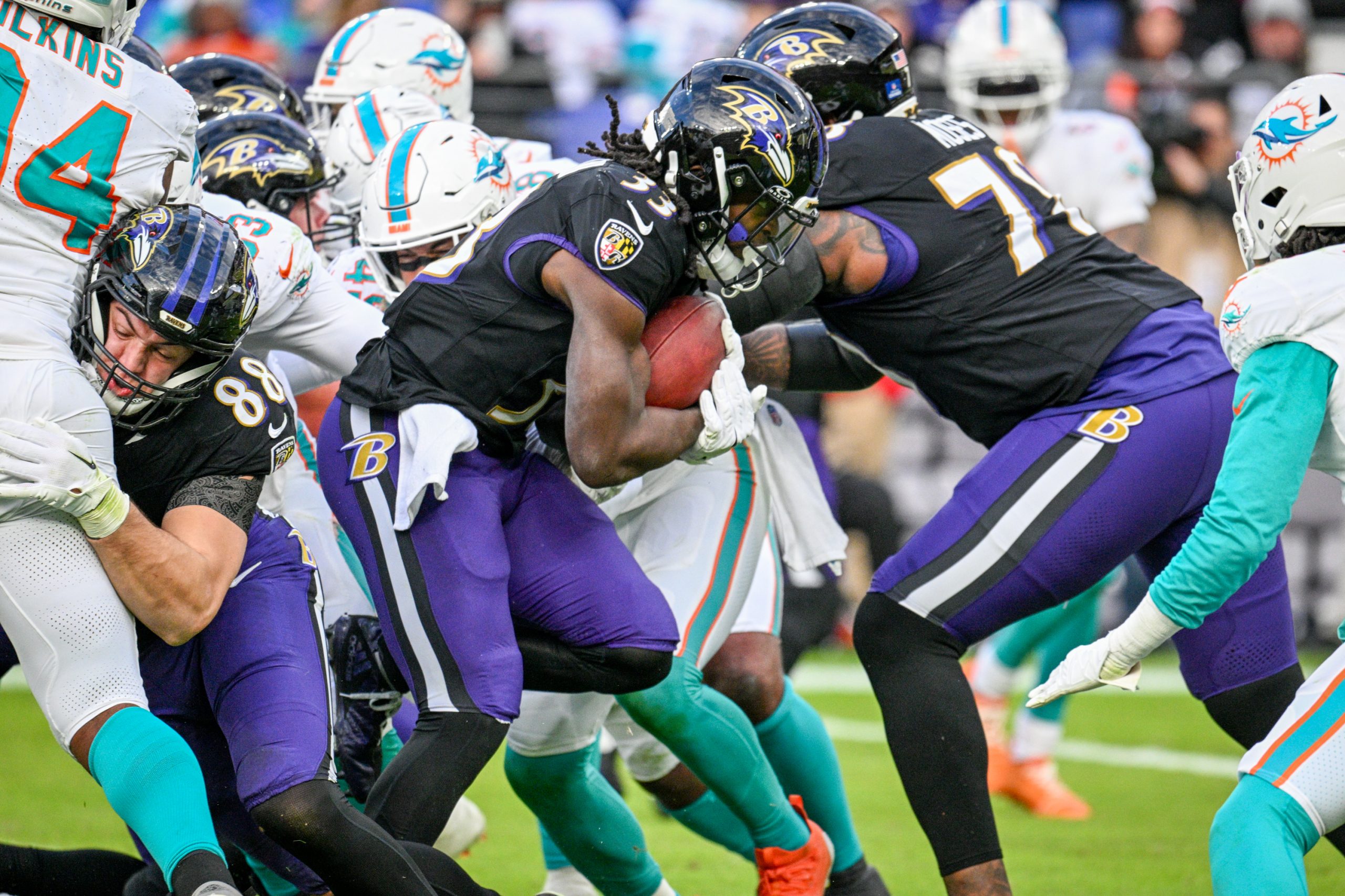 Baltimore Ravens Melvin Gordon III pushes through for a gain...