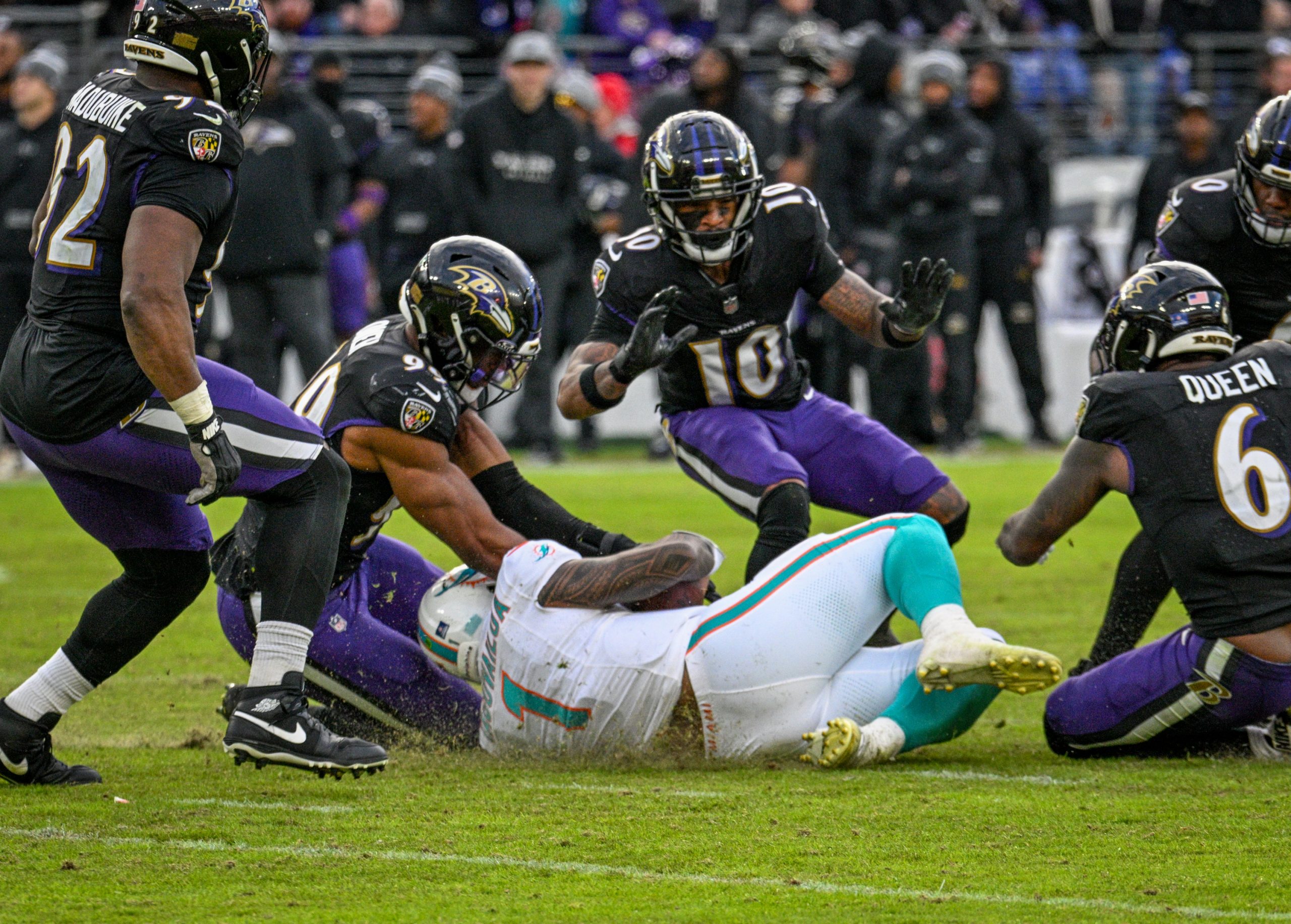 Miami Dolphins quarterback Tua Tagovailoa slides into a bunch of...