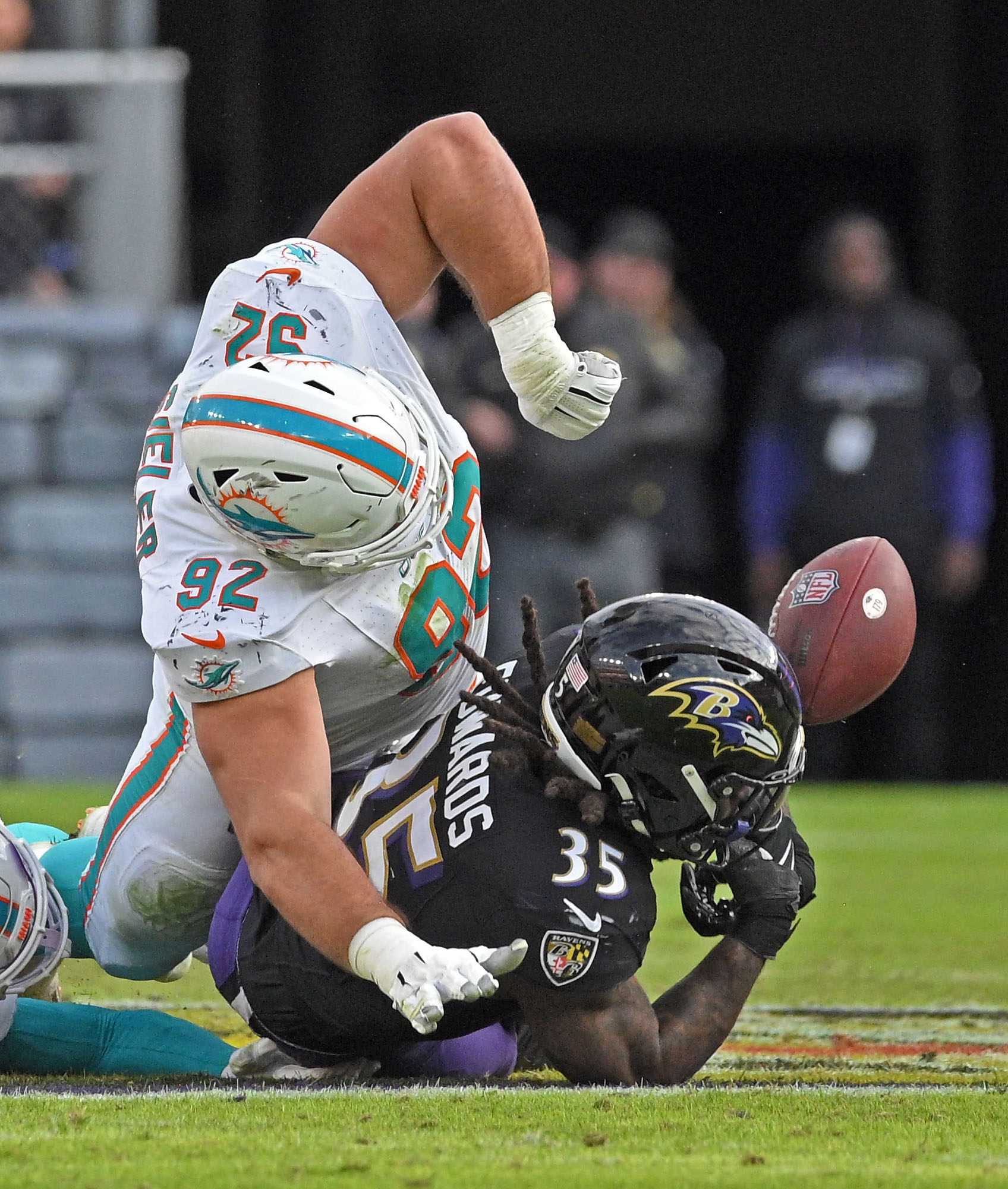 Dolphinsxe2x80x99 Zach Sieler, top, strips the ball from Ravens running...