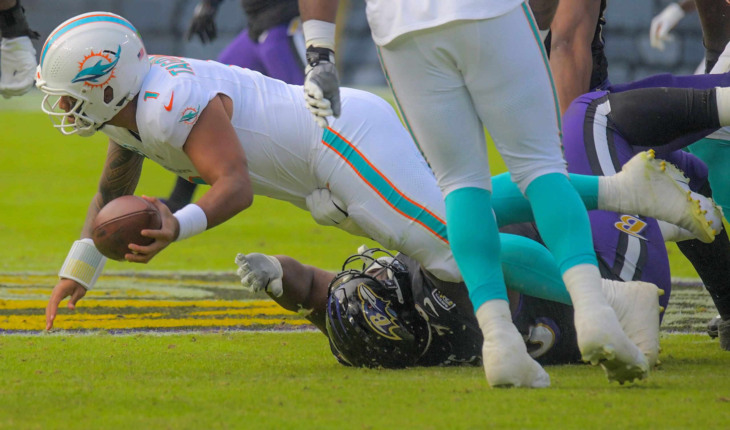 Baltimore Ravens nose tackle Michael Pierce drags down Miami Dolphins...