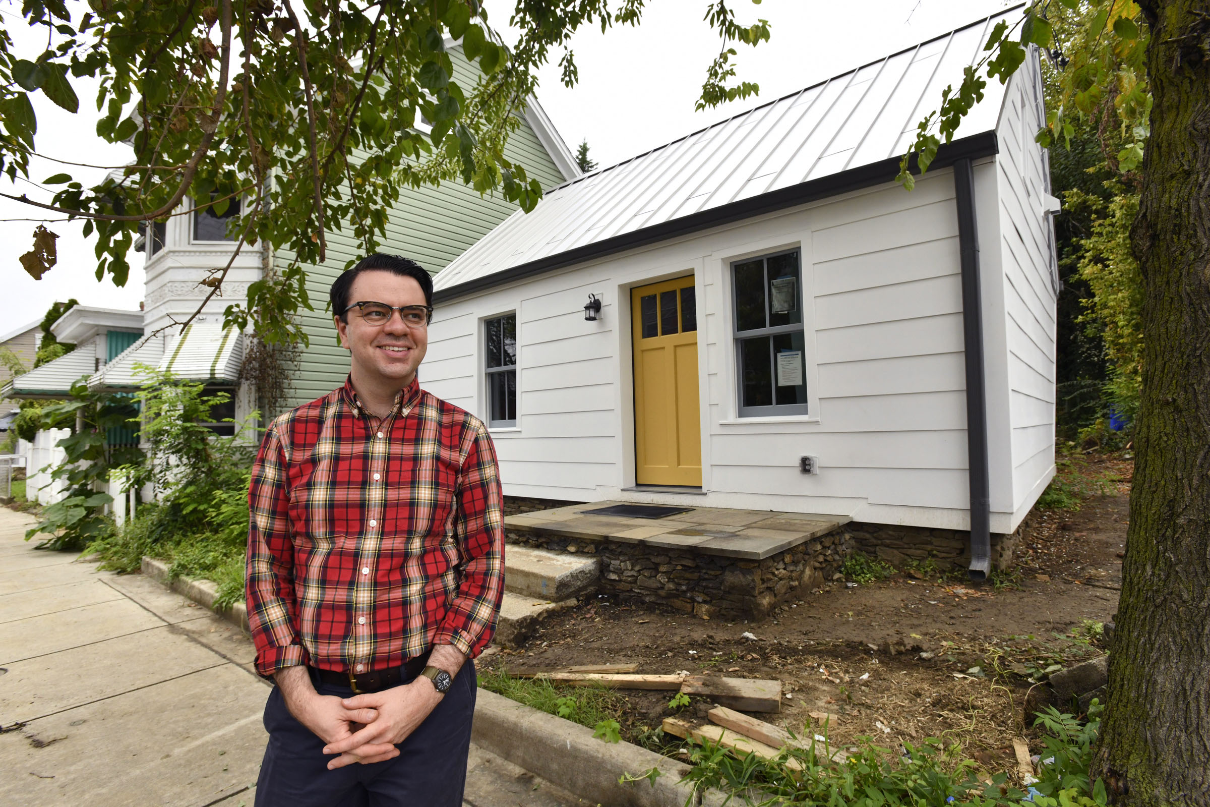 Nicholas Redding, president of Preservation Maryland, outside the log cabin...