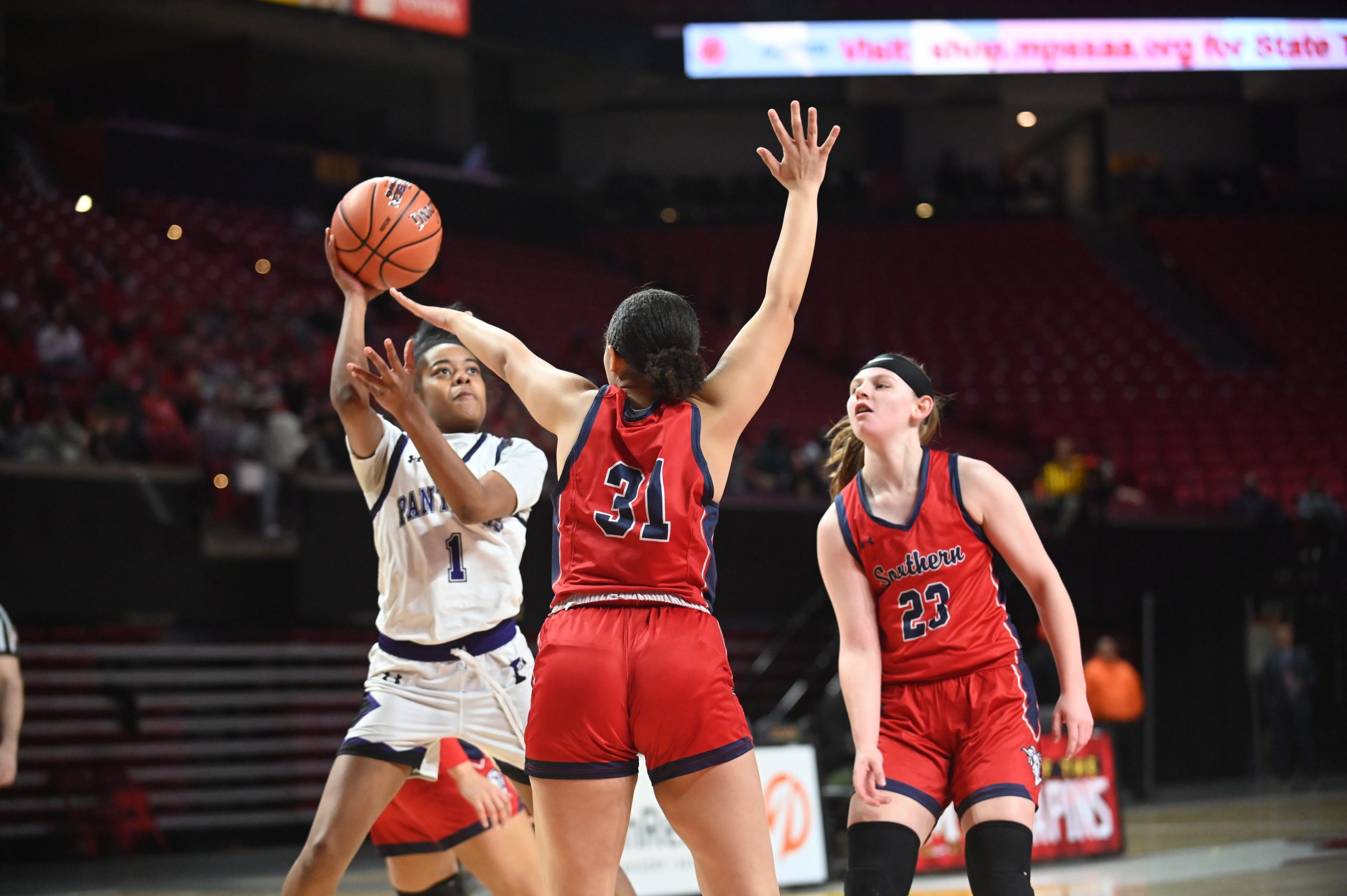 Pikesville's Mariah Jones-Bey tries to get a shot off with...