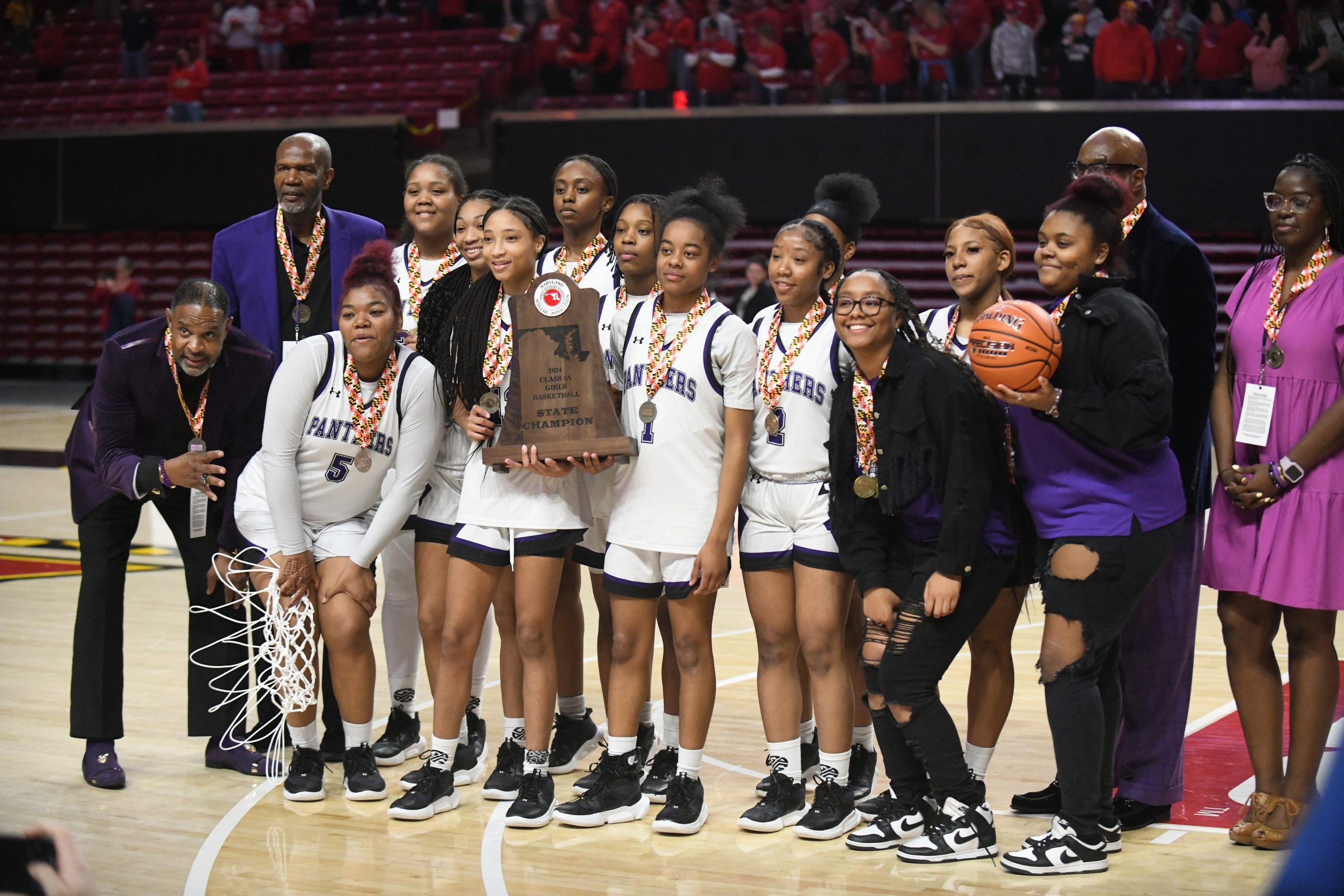 Pikesville's girls basketball team poses with thei trophy following their...