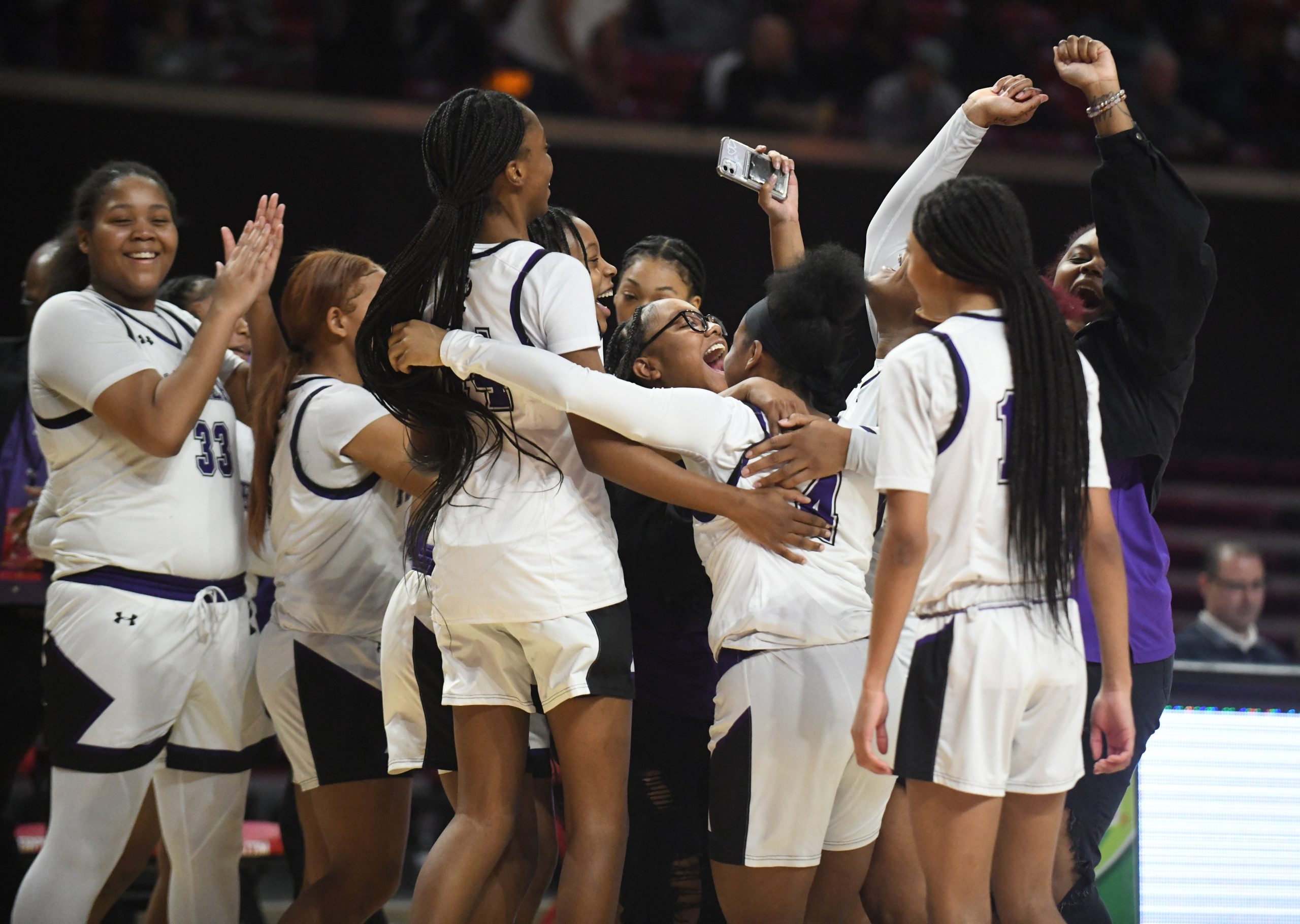 The Pikesville girls basketball team celebrates its win over Southern-Garrett...