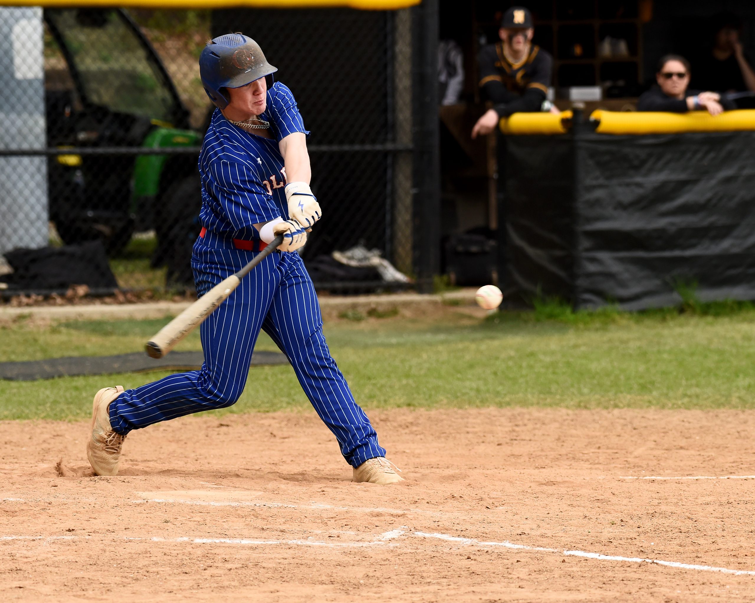 Old Mill’s Brady Tinger hits an RBI single in the...