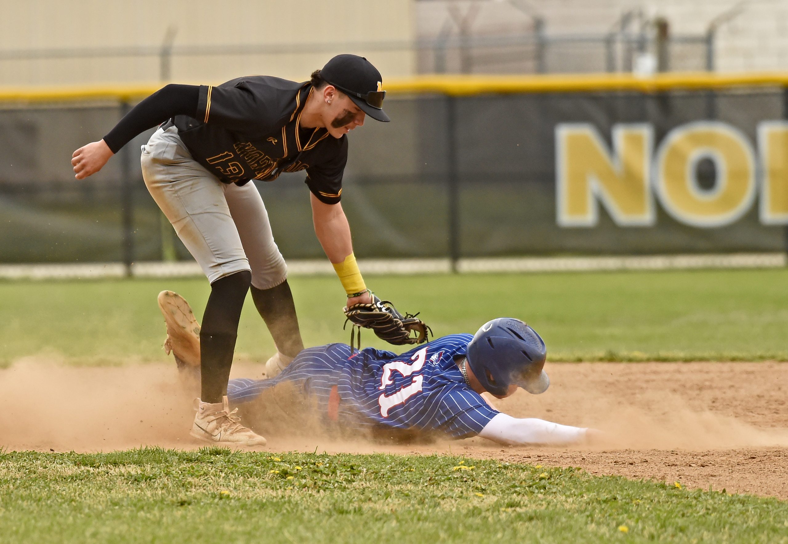 Old Mill’s Brady Tinger is caught stealing at second base...