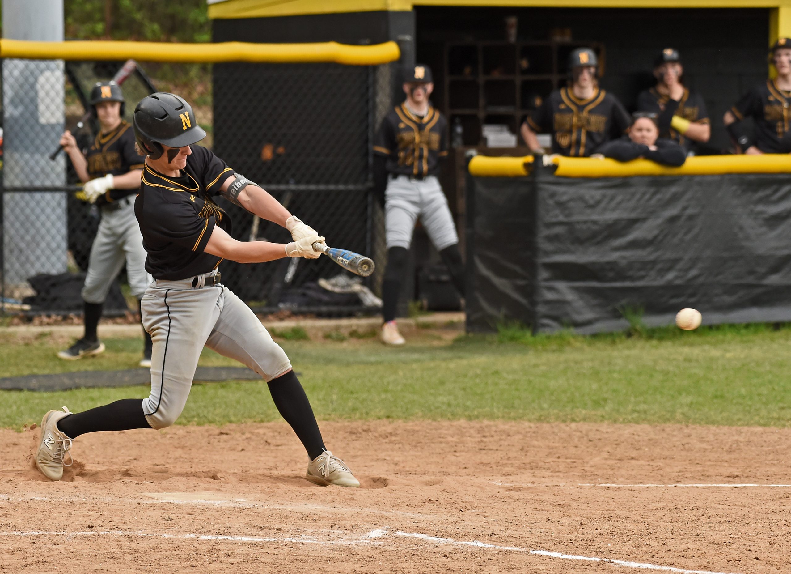 Northeast’s Jack Schreiber gets a piece of the ball and...