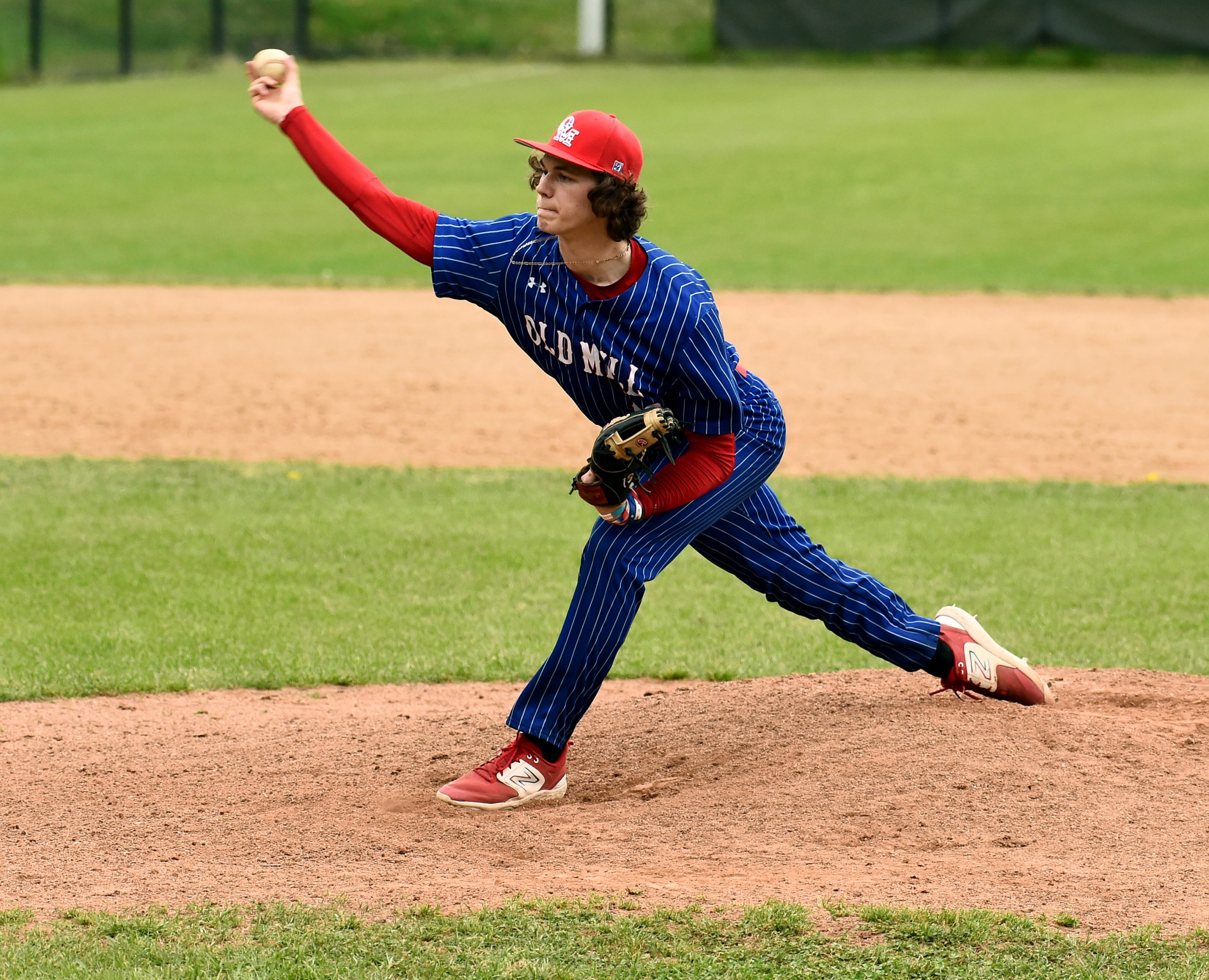 Old Mill pitcher Gavin Glos throws in the fourth inning....