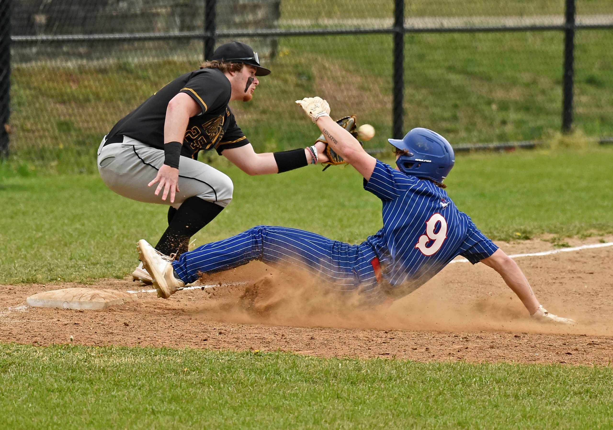 Old Mill’s Ayden Burton beats the throw to Northeast third...