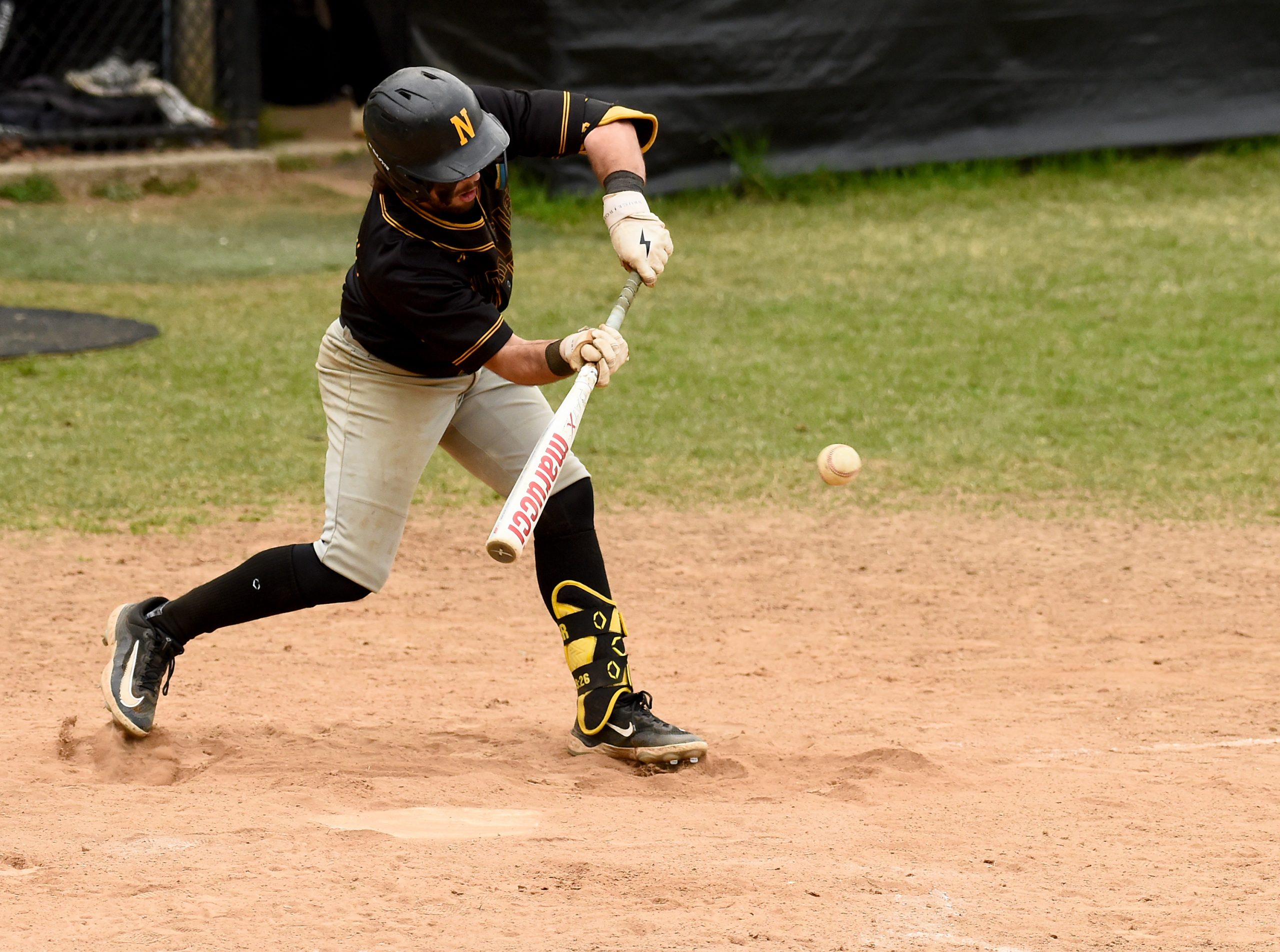 Northeast’s Mike Kooser lays down a sacrifice bunt to advance...