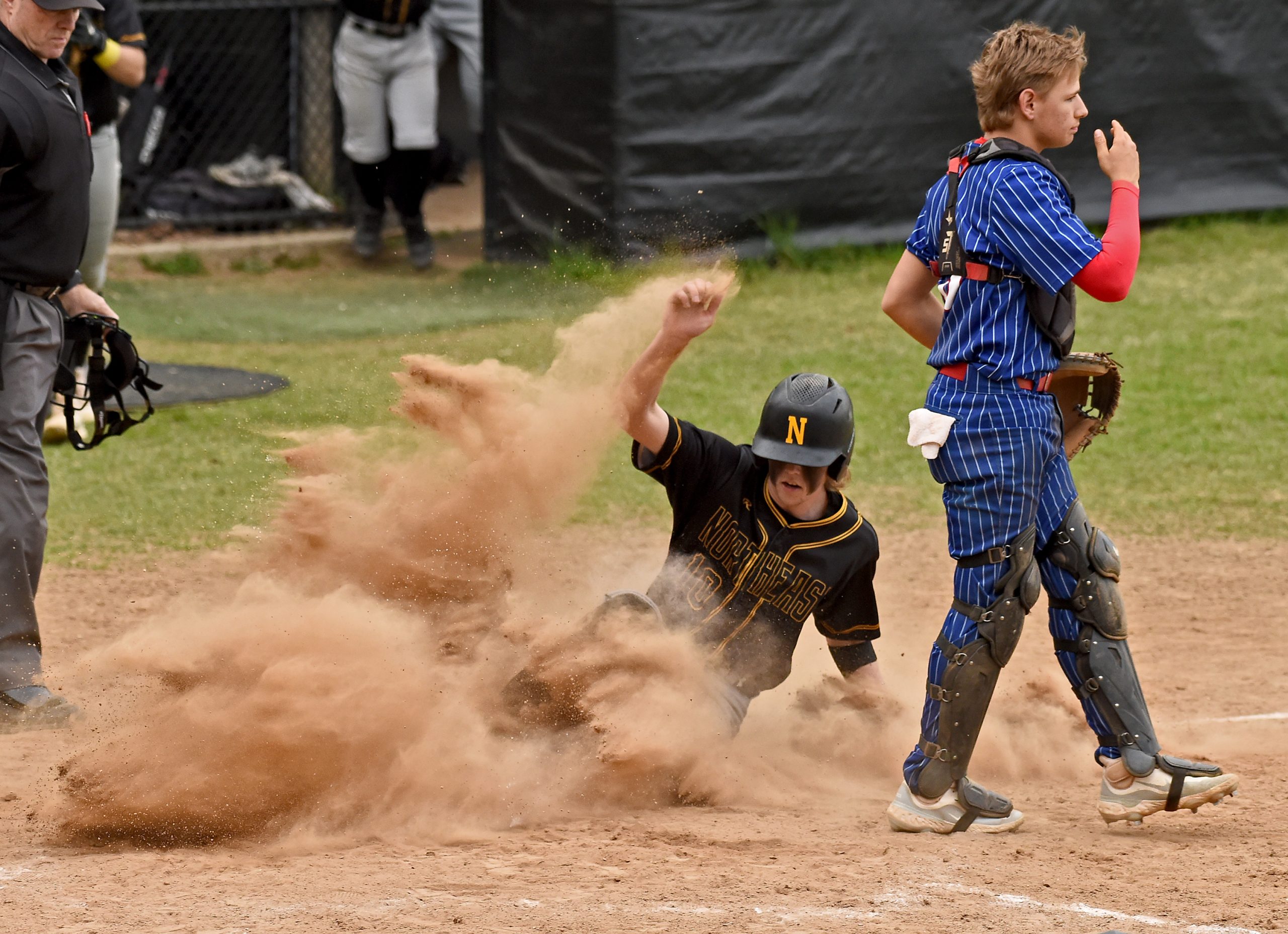 Northeast’s Jackson Palmer scores the winning run on a bunt...