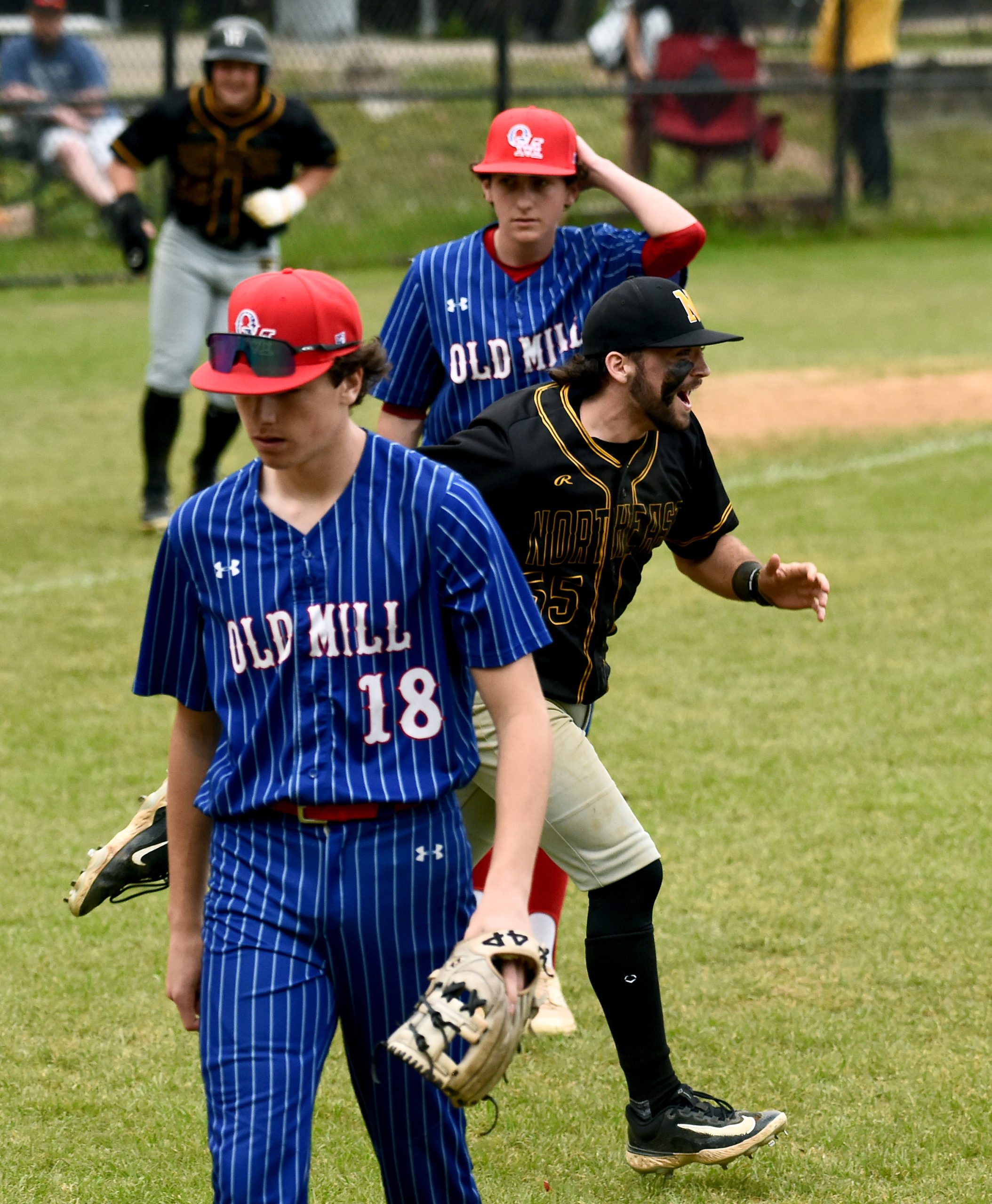 Northeast winning pitcher Mike Kooser runs out to celebrate with...