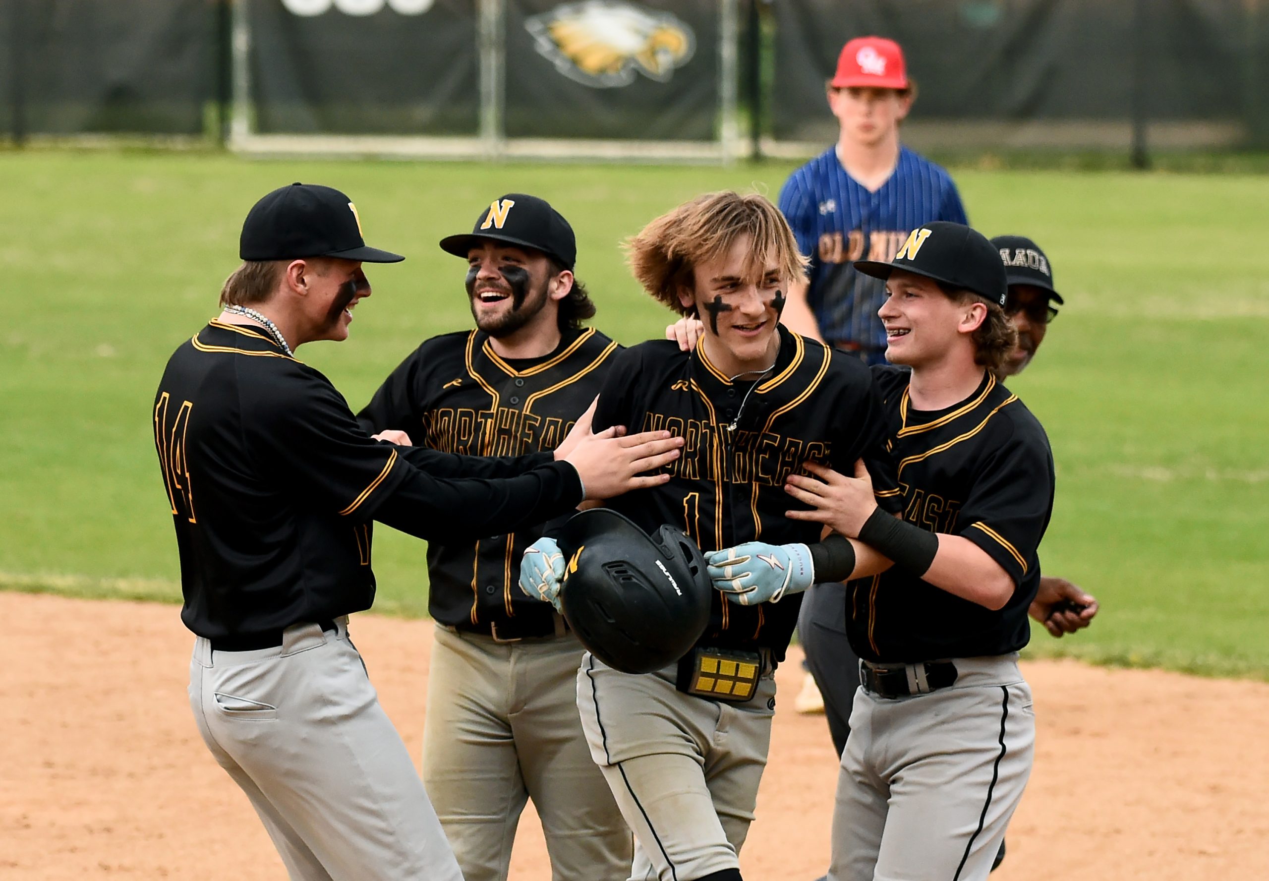 Northeast’s Landon Shriver, center right, who bunted in the winning...
