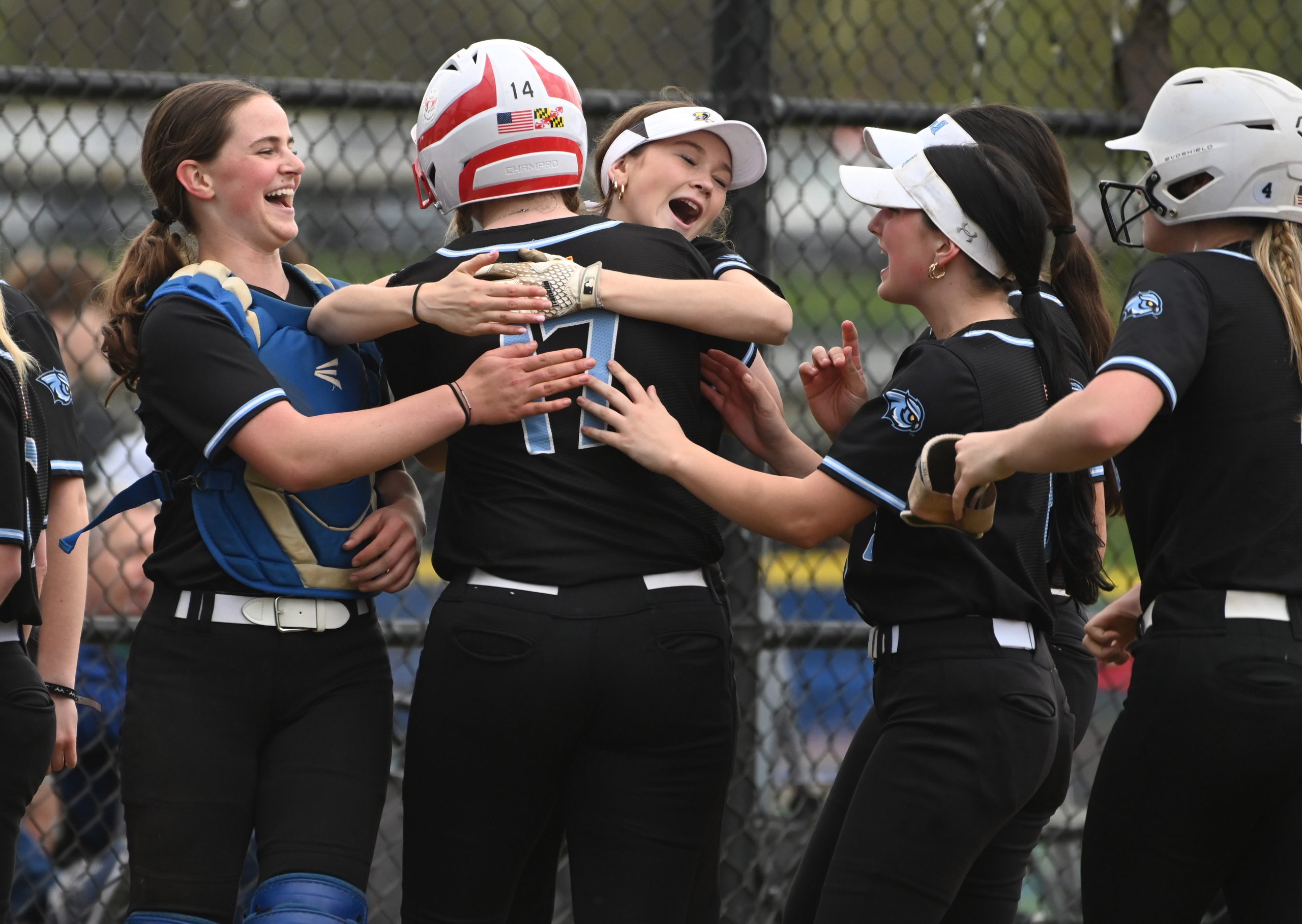Westminster's Lila Moxley is embraced by teammate Gina Sullivan as...
