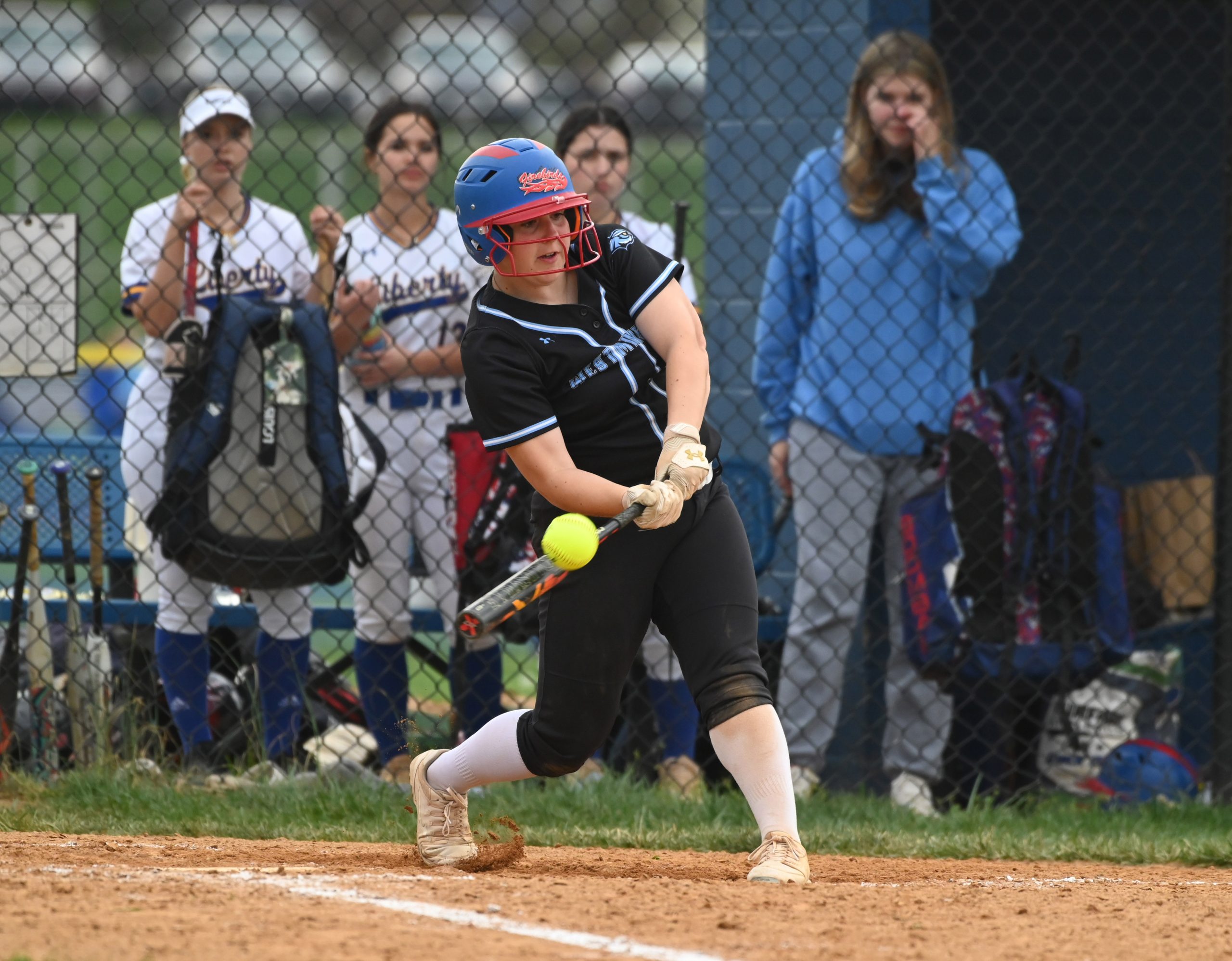 Westminster's Brianna Witter connects with a basehit during a softball...