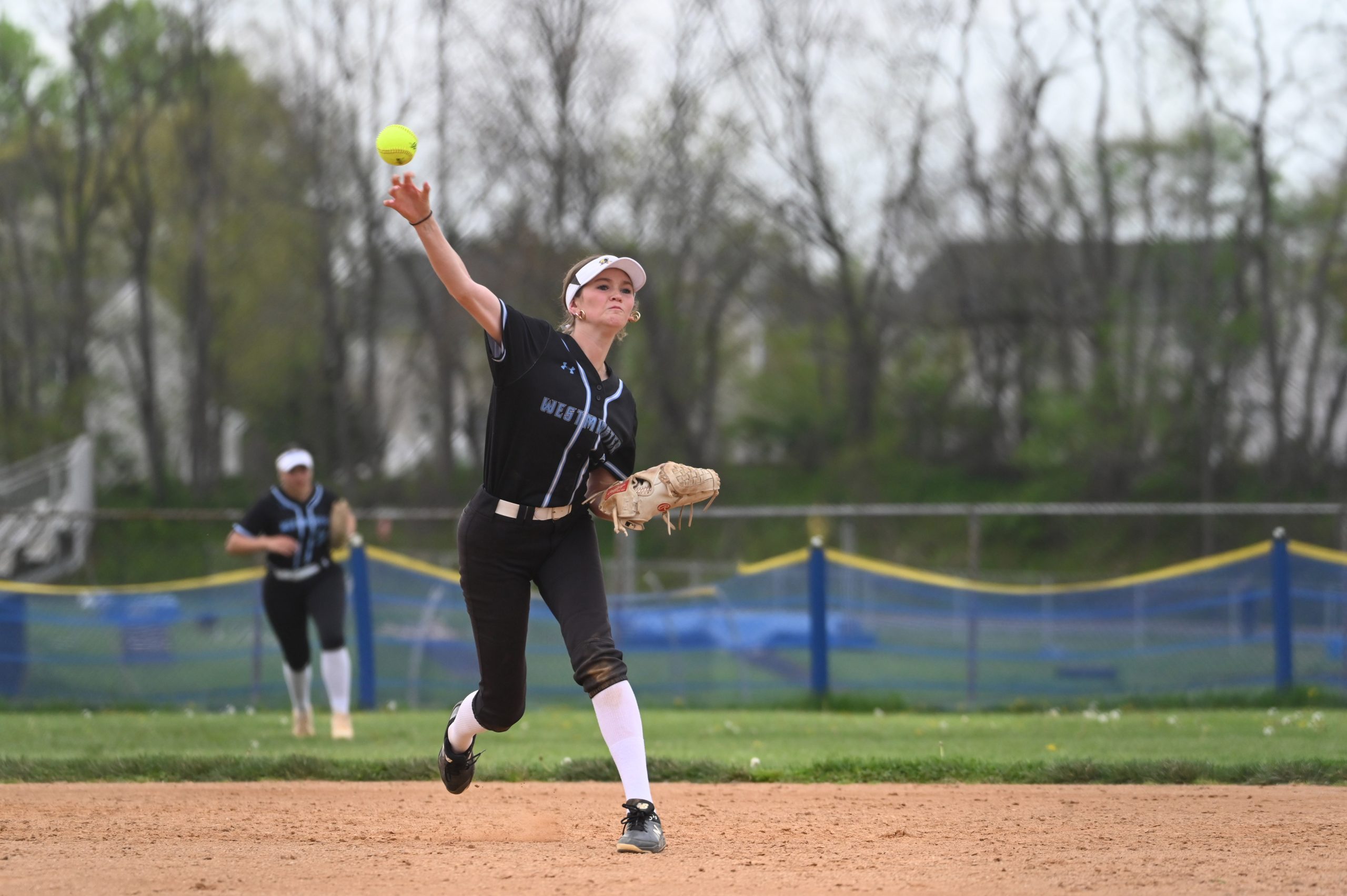 Westminster shortstop Gina Sullivan throws out a Liberty runner after...