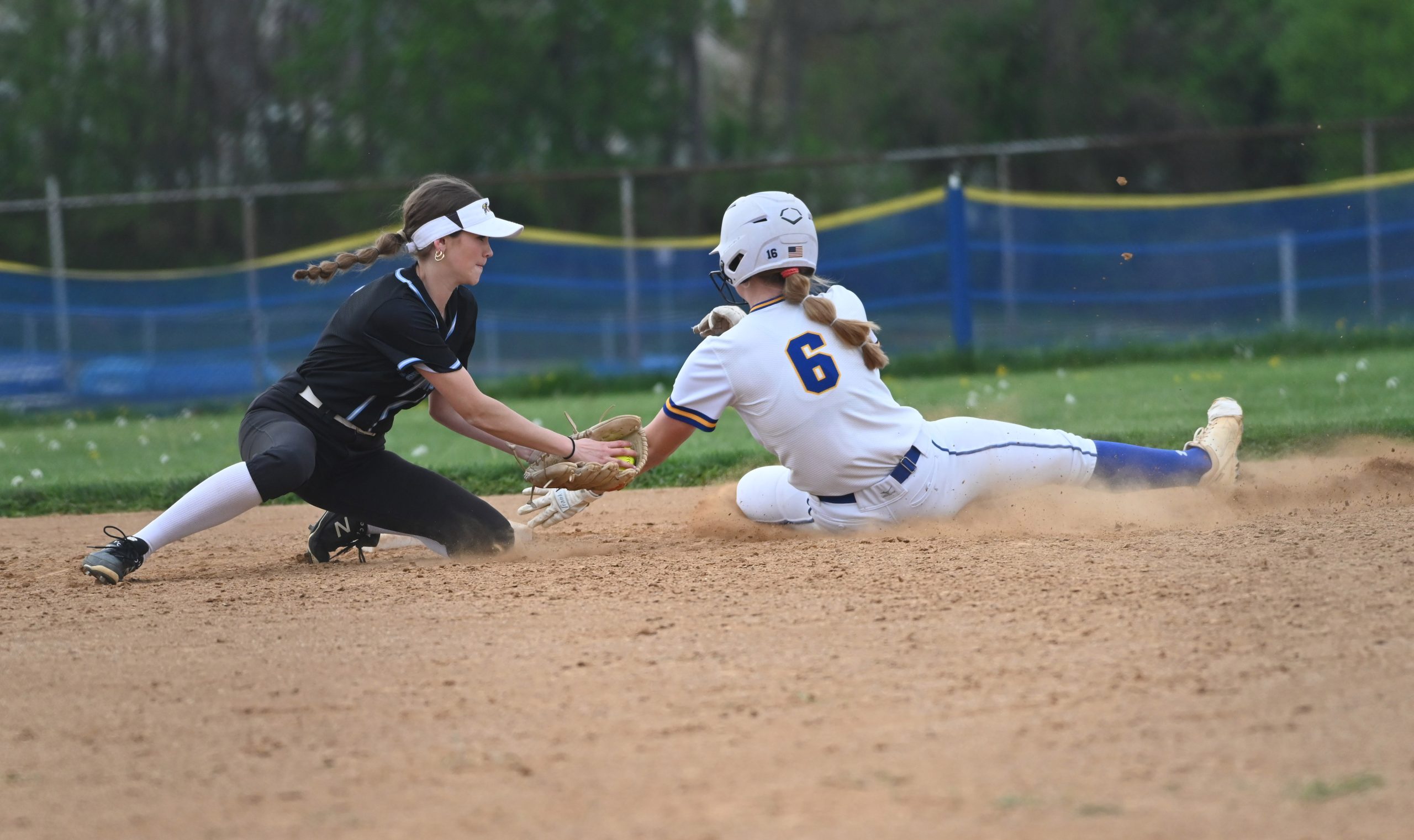 Westminster shortstop Gina Sullivan tries to tag out Liberty runner...