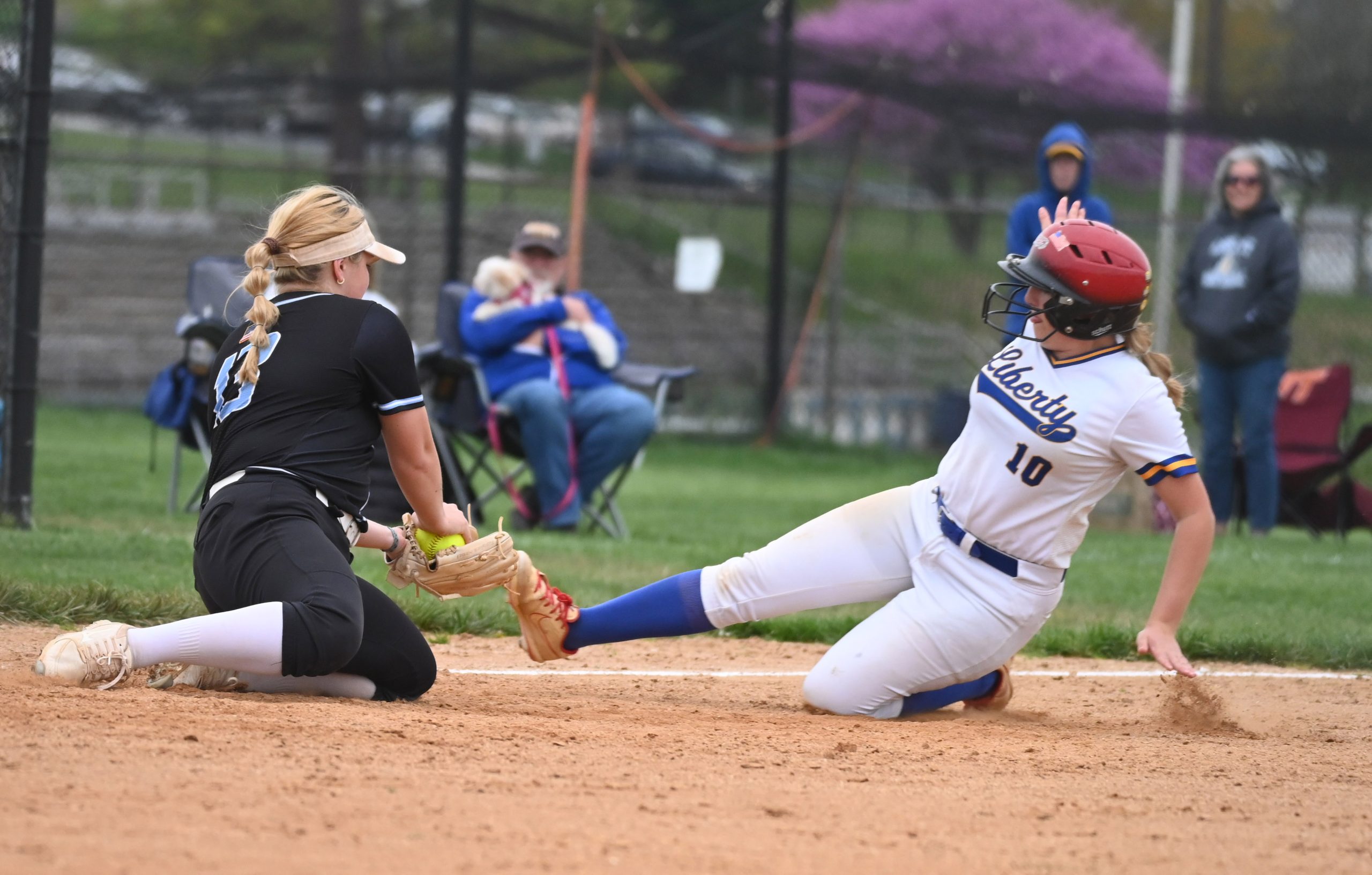 Westminster third baseman Brianna Witter tags out Liberty's Hannah DeVincent...