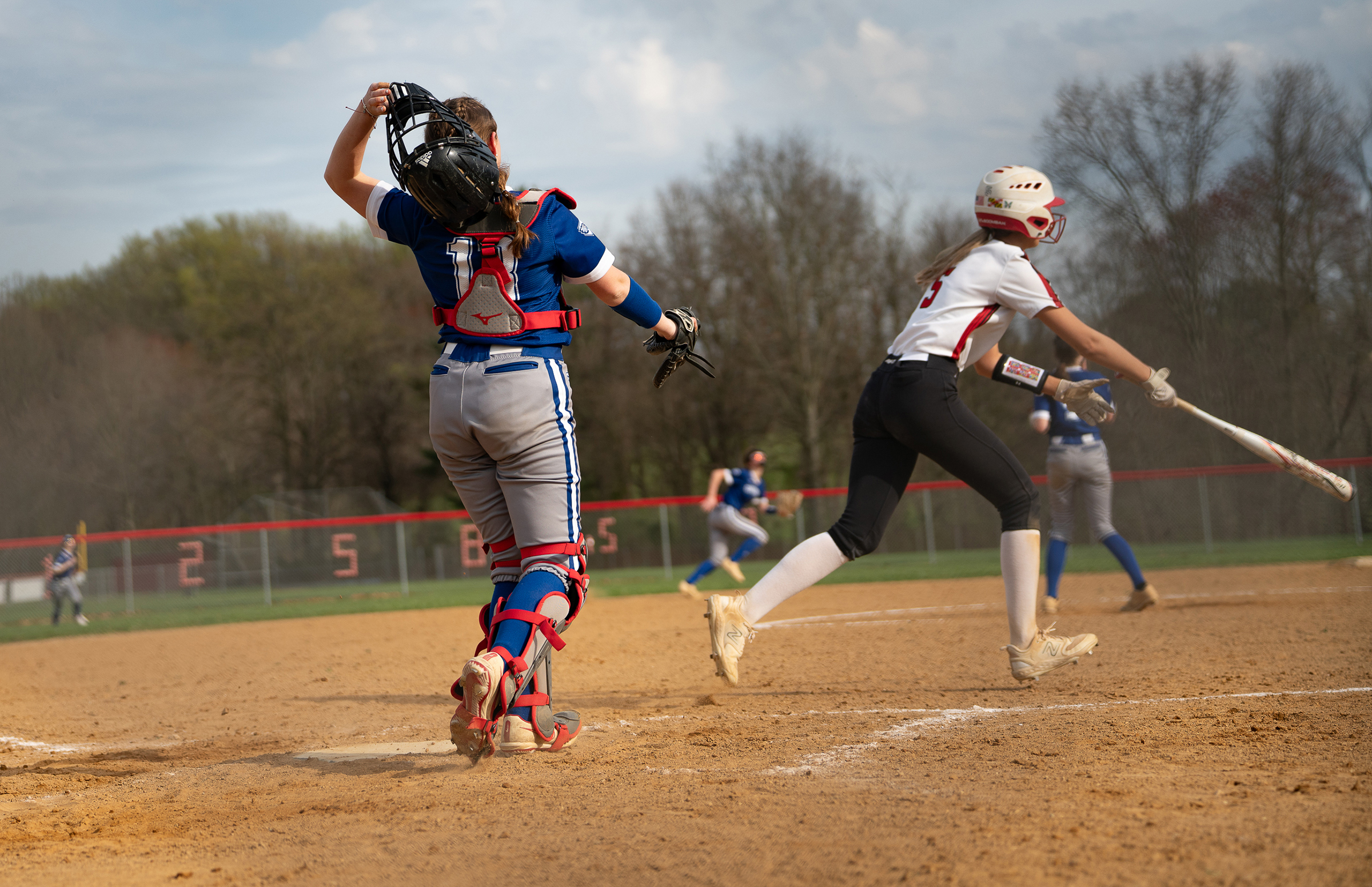April 8, 2024 Centennial catcher #13, Sarah Middleton, sheds her...