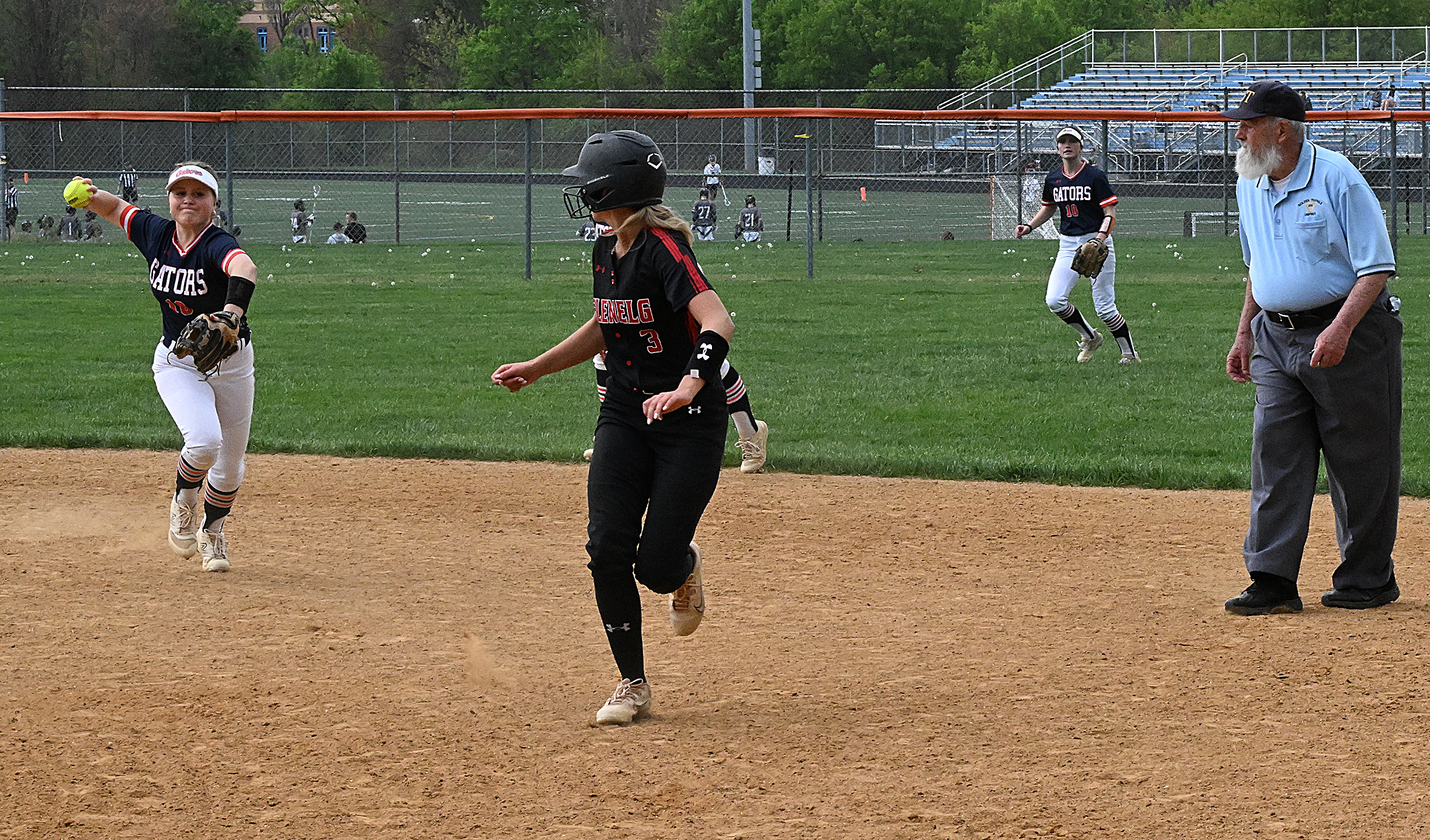 Glenelg #3, Reese Holden is caught in a run-down between...