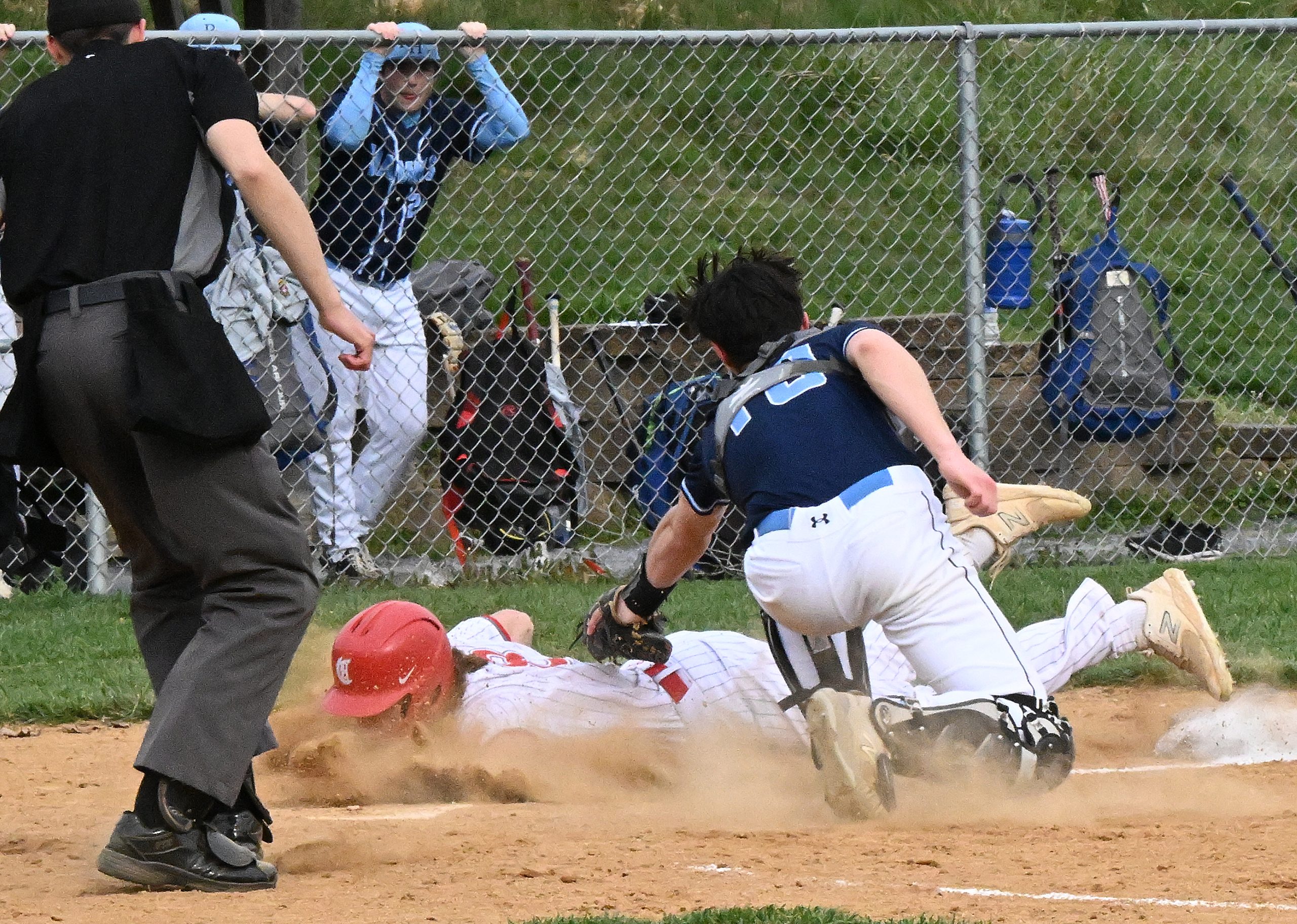 Centennial #8, Zach Kelly is safe on a play at...