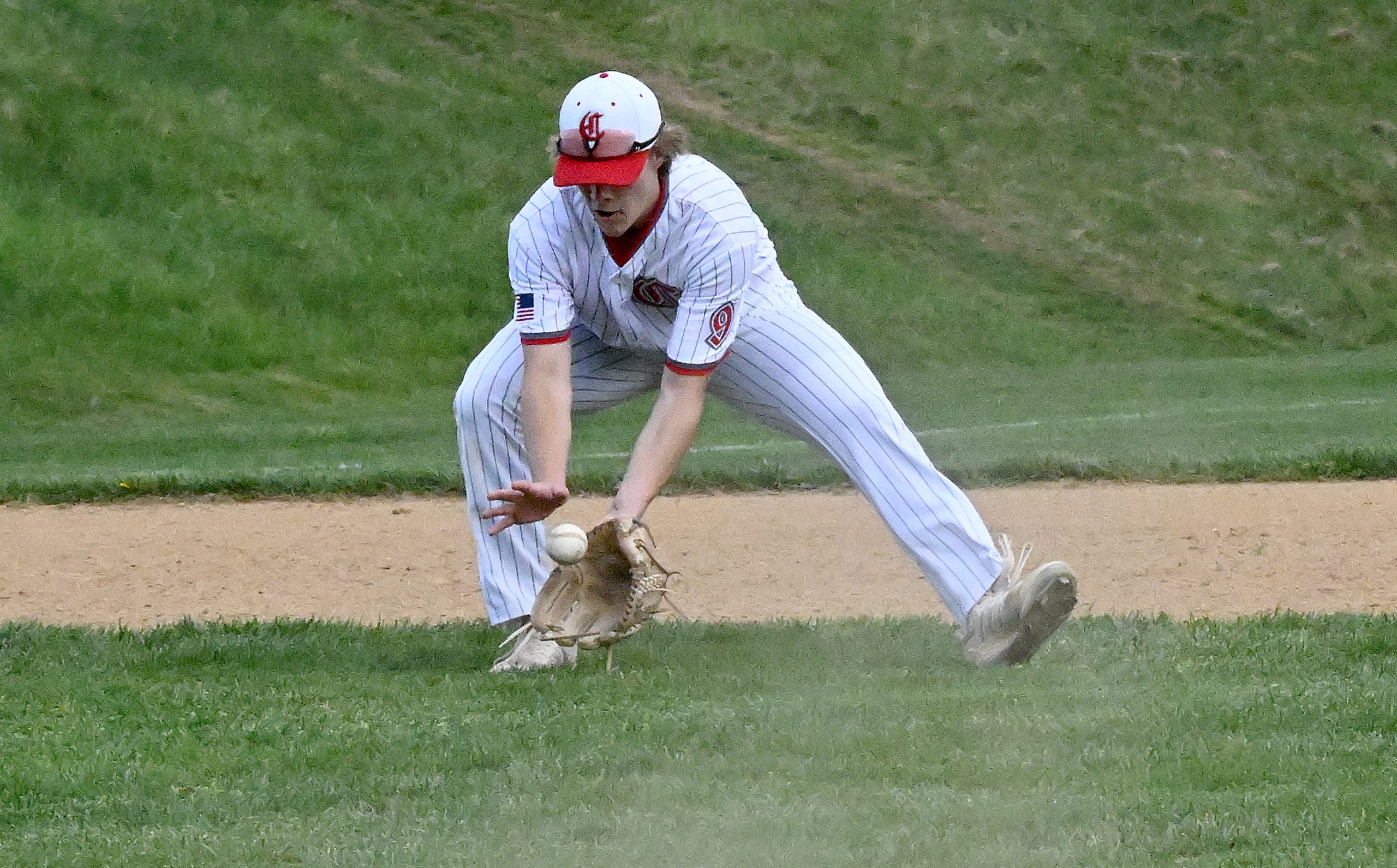 Centennial 3rd baseman #9, Jack Stachera makes a play on...