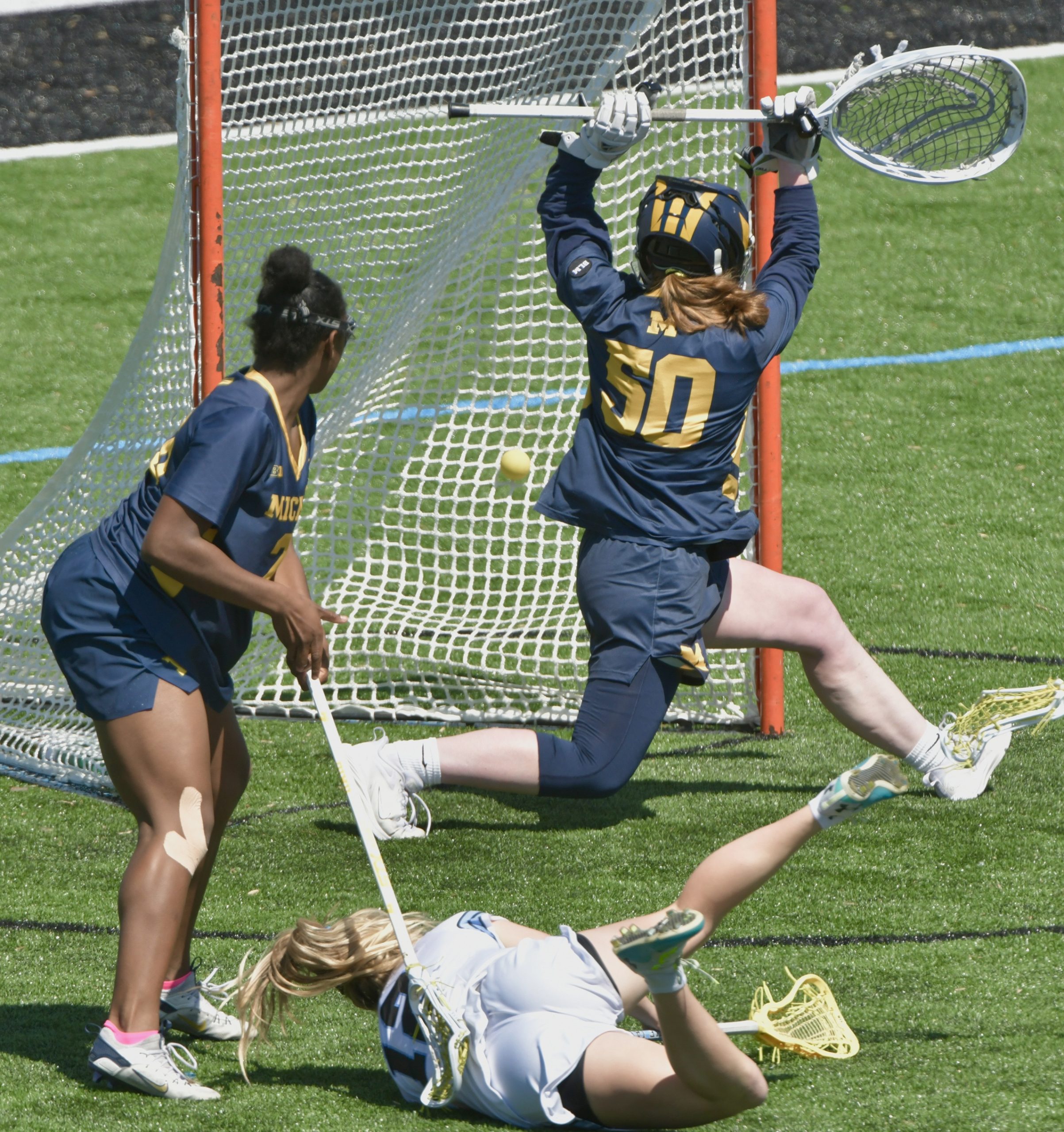 Johns Hopkins’ Bailey Cheetham #12 lands on the grass after...