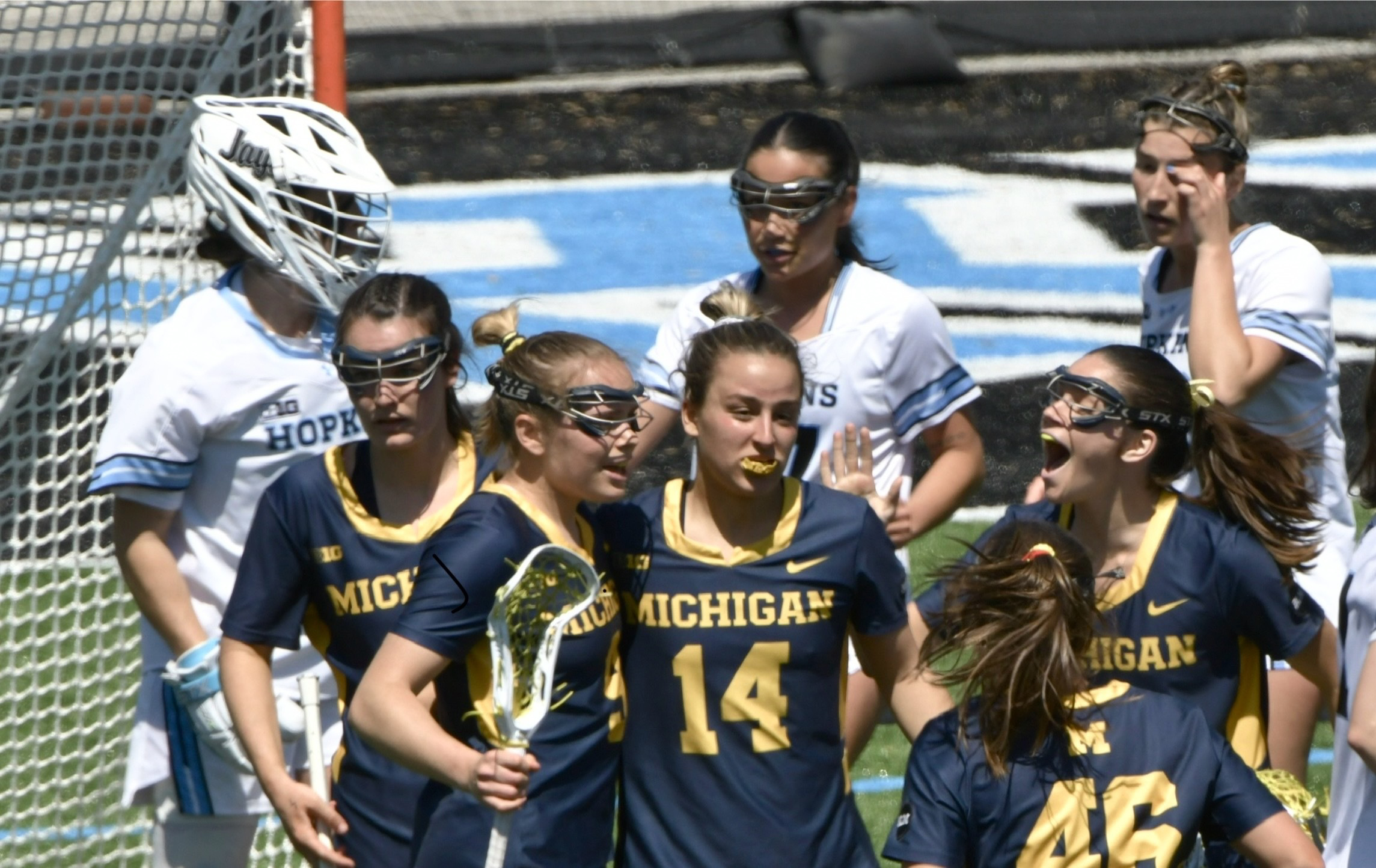 Johns Hopkins’ goalkeeper Madison Doucette, left, and teammates look on...