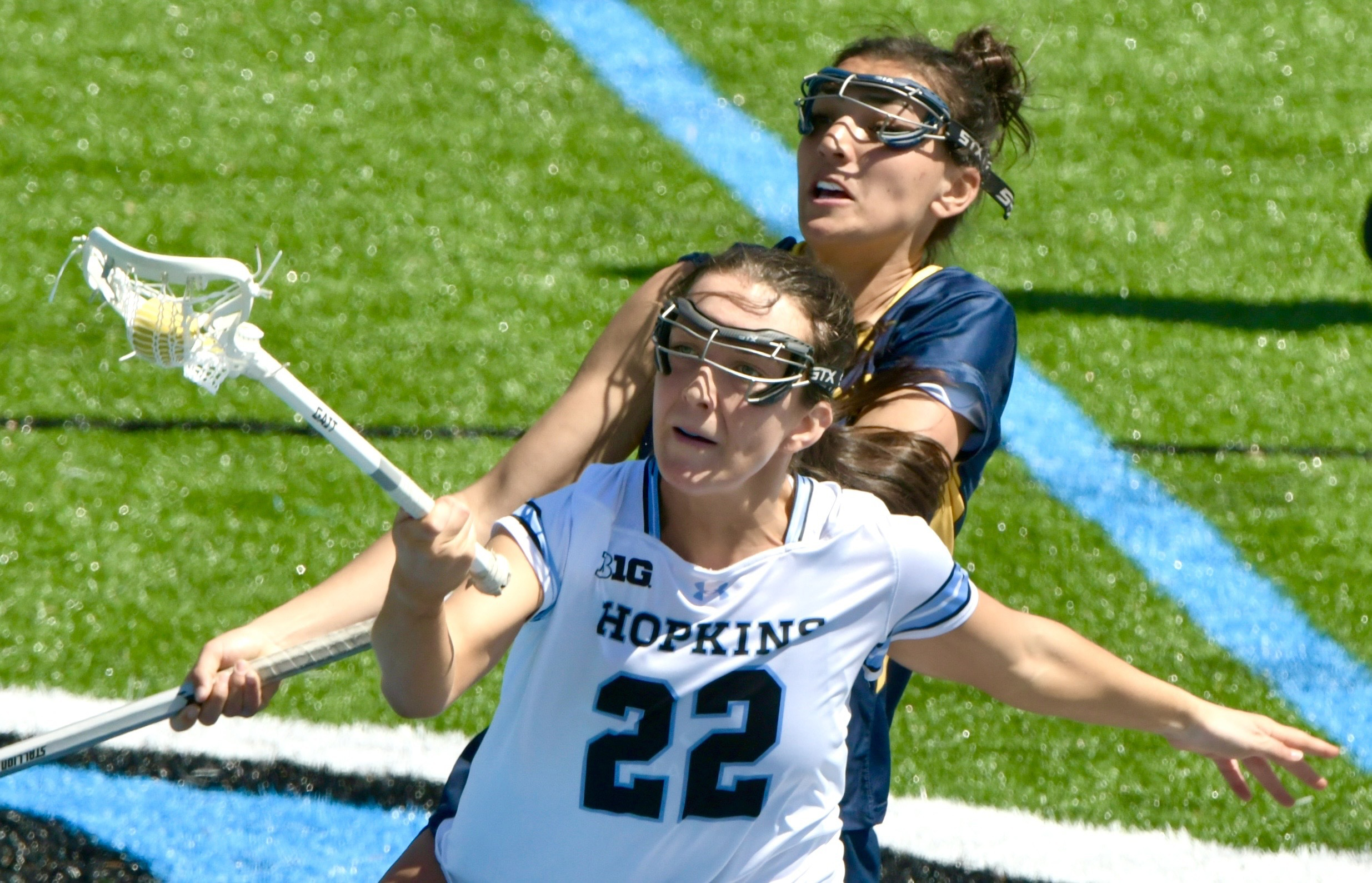 Johns Hopkins’ Jennifer Barry #22, front, captures the ball after...