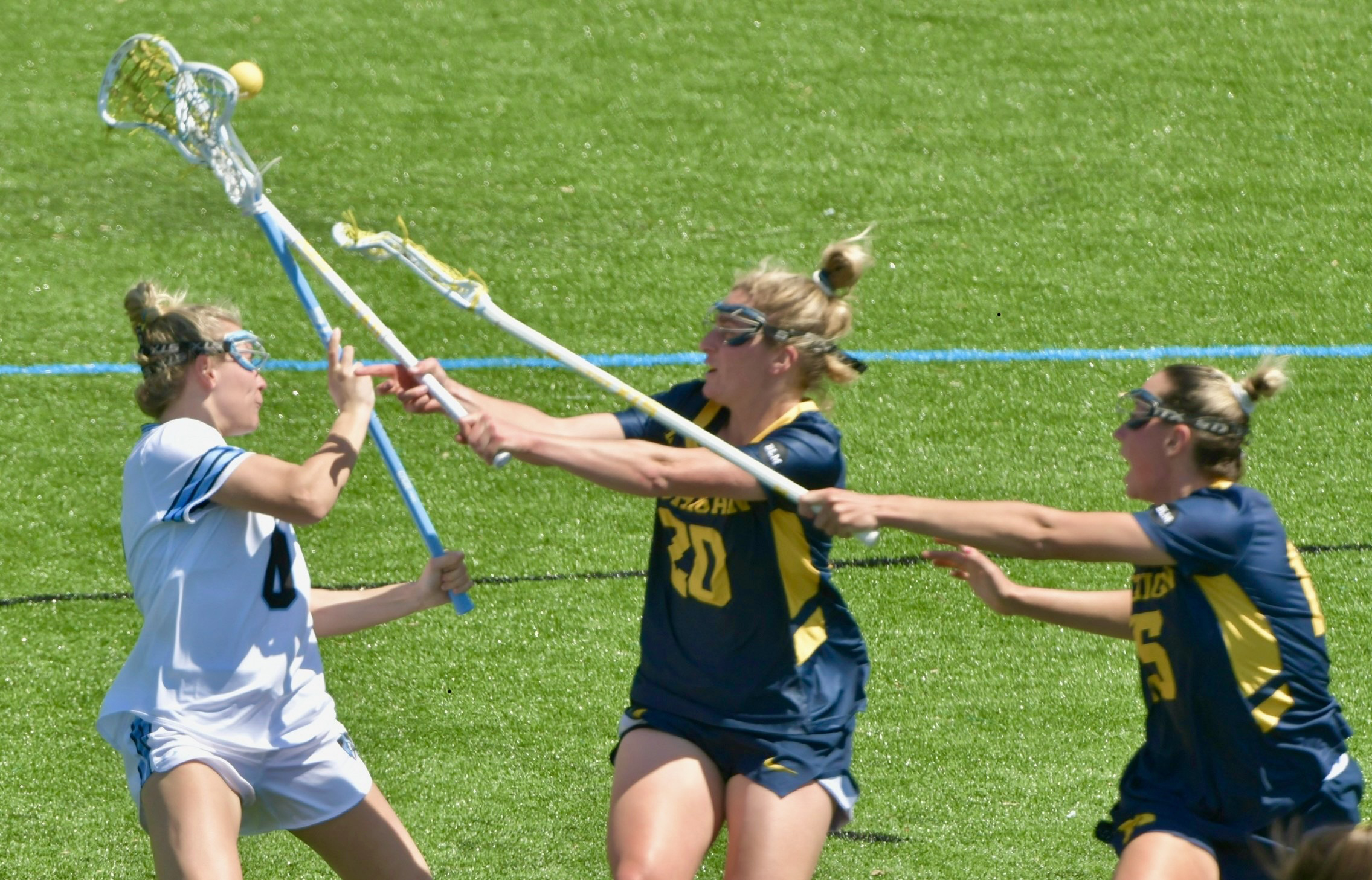 Michigan’s Ava Class #20, center, and Maya Rutherford #15 double-team...