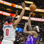 Mar 4, 2024; Salt Lake City, Utah, USA; Utah Jazz guard Jordan Clarkson (00) takes a shot over Washington Wizards guard Bilal Coulibaly (0) during the second half at the Delta Center. Mandatory Credit: Christopher Creveling-USA TODAY Sports