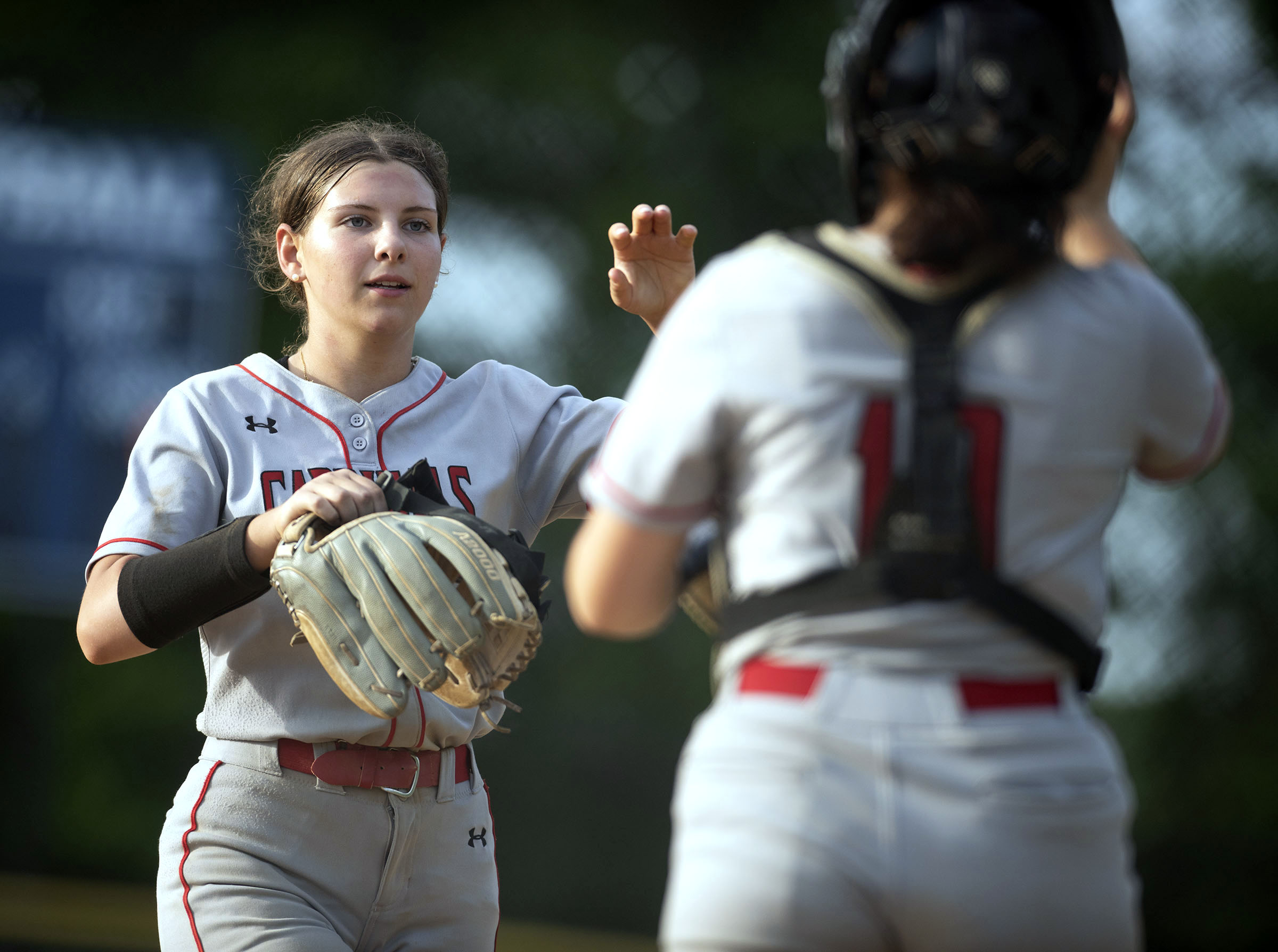 Crofton pitcher Lynsie Herman, left, high fives catcher Makenzie Reyes...