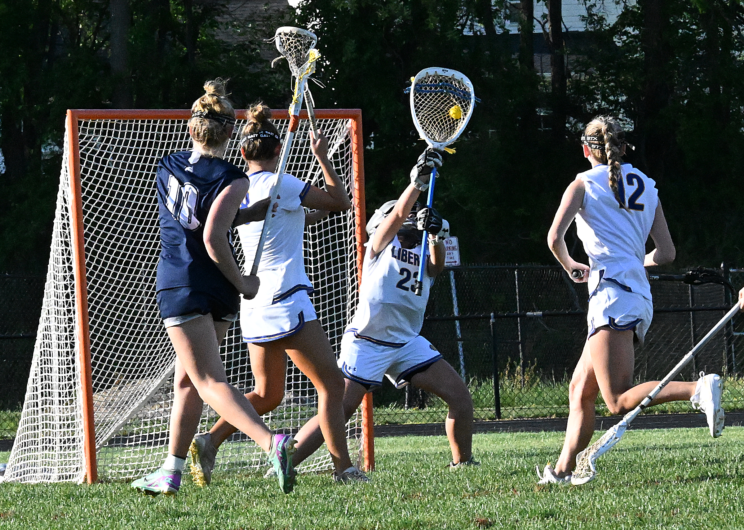 Liberty goalie #23, Emily Pond makes a save on a...