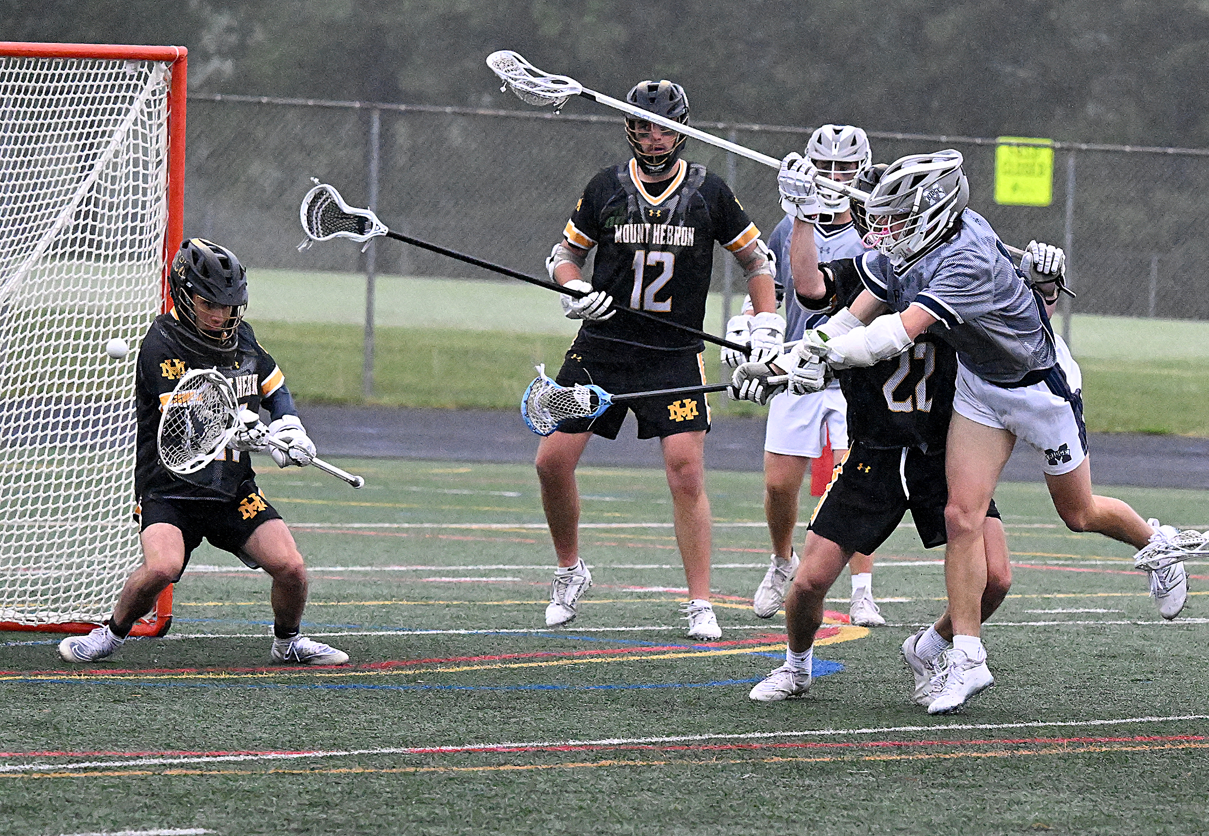 Mt. Hebron goalie #11, Luca LeClaire, makes a save deflecting...