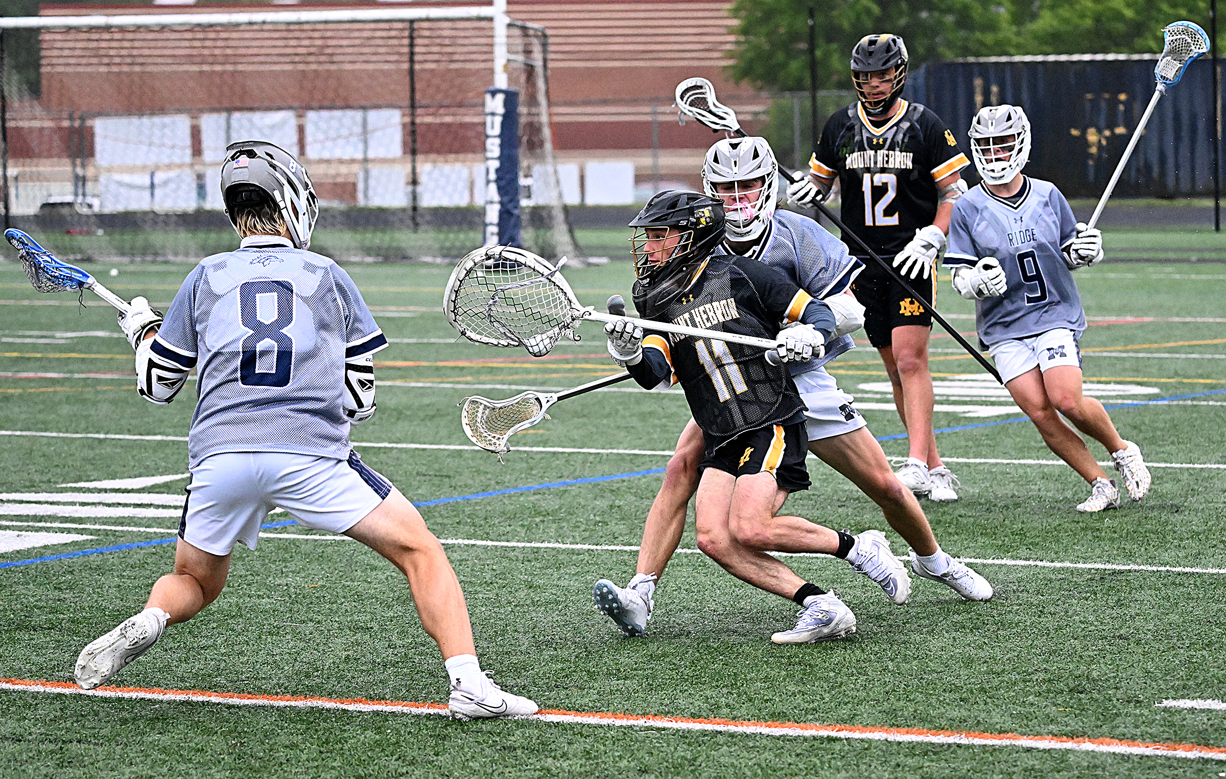 Mt. Hebron goalie #11, Luca LeClaire runs the ball up...