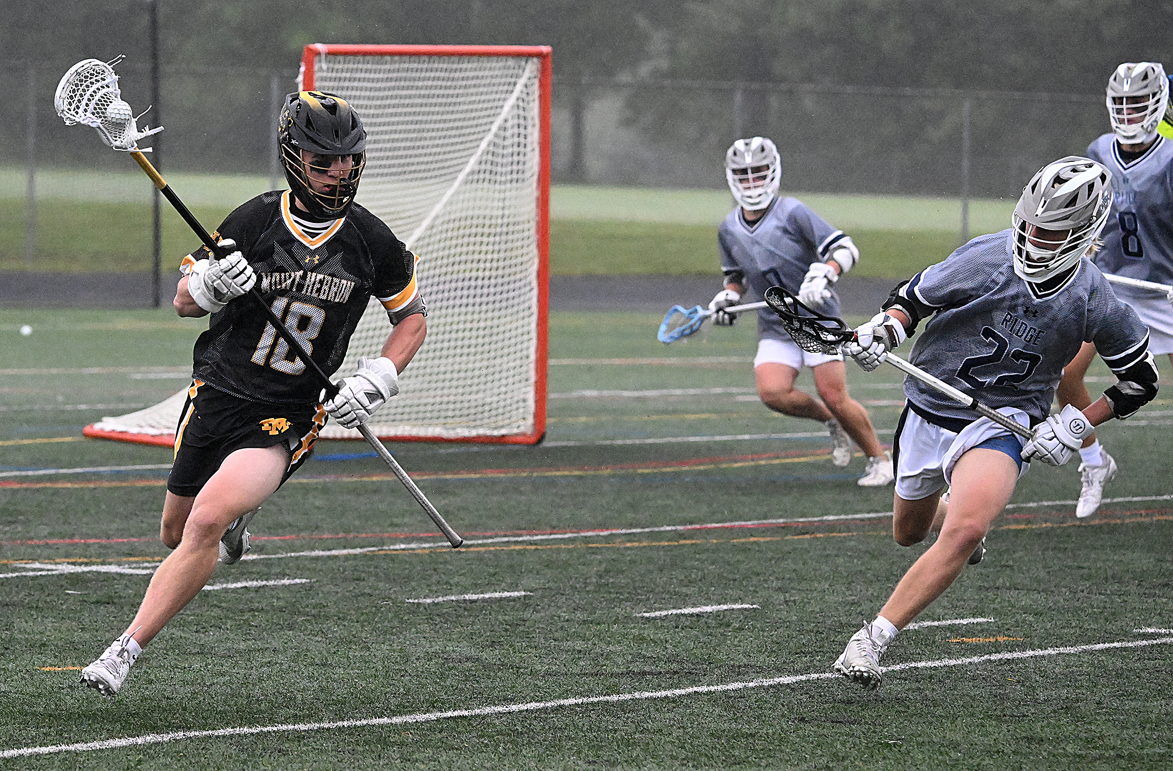 Mt. Hebron #18, Aidan Dunn gains possession and runs up...