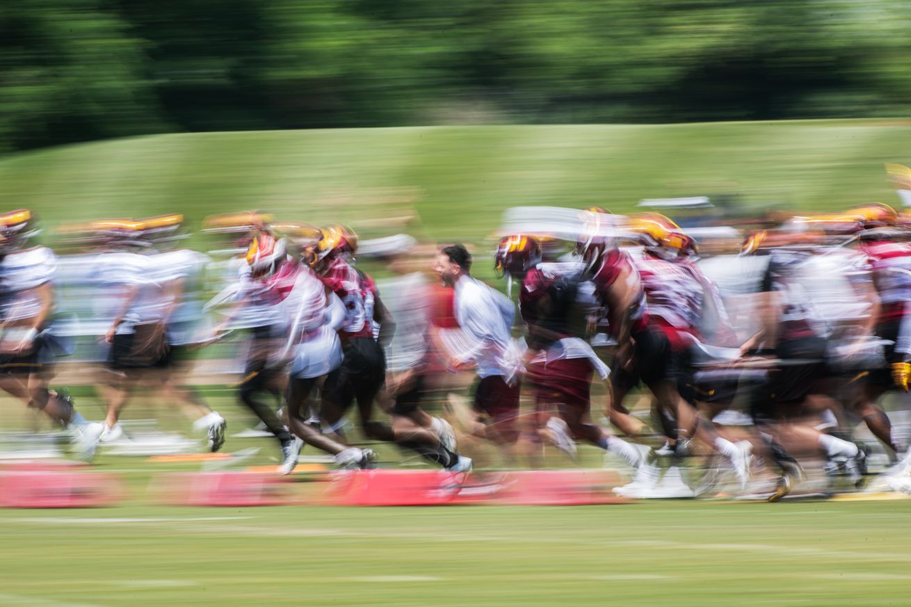 ASHBURN, VA - MAY 22: Washington Commanders players rally betw