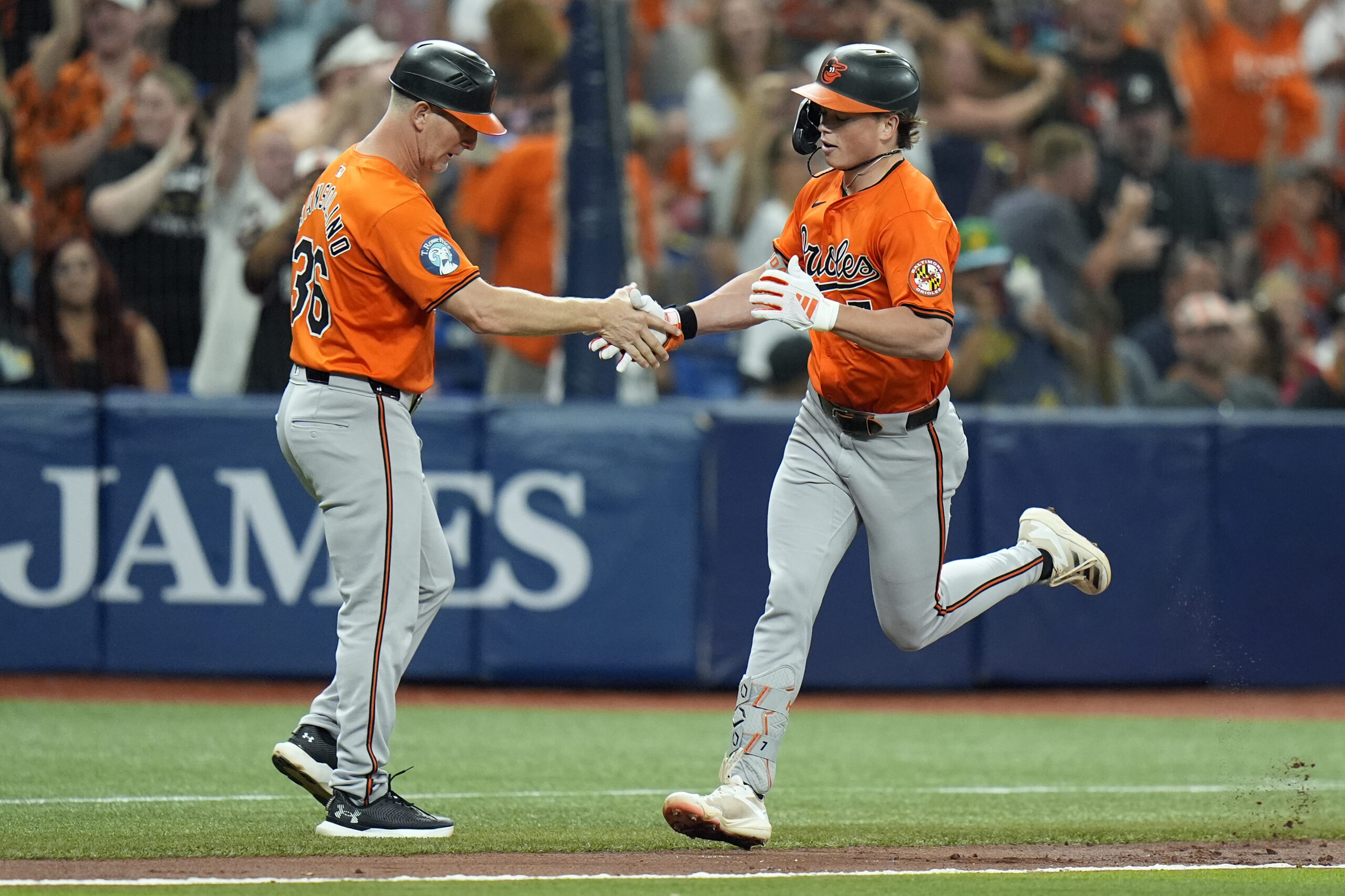 Baltimore Orioles' Jackson Holliday celebrates with third base coach Tony...