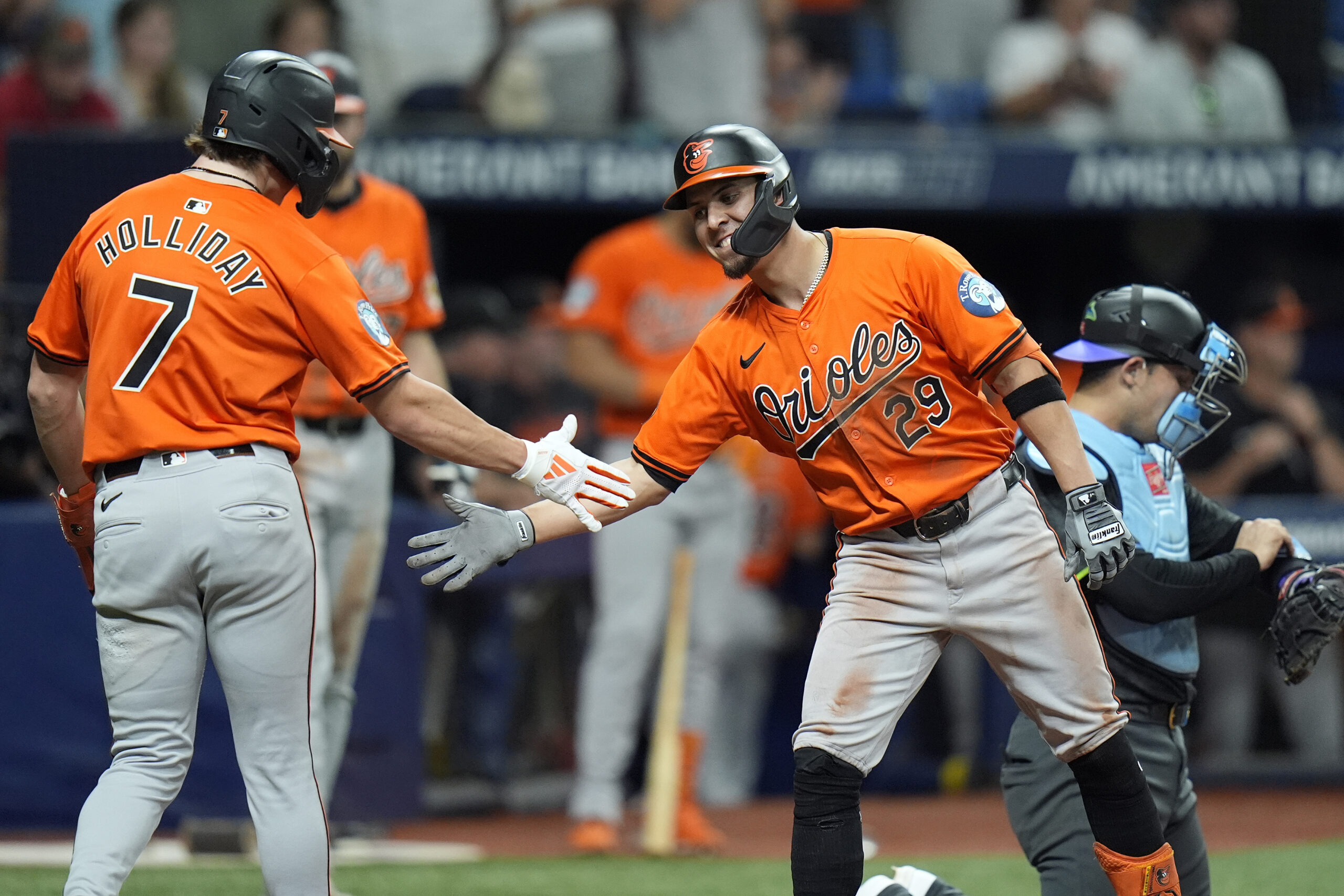 The Orioles' Ramón Urías, right, celebrates his two-run home run...