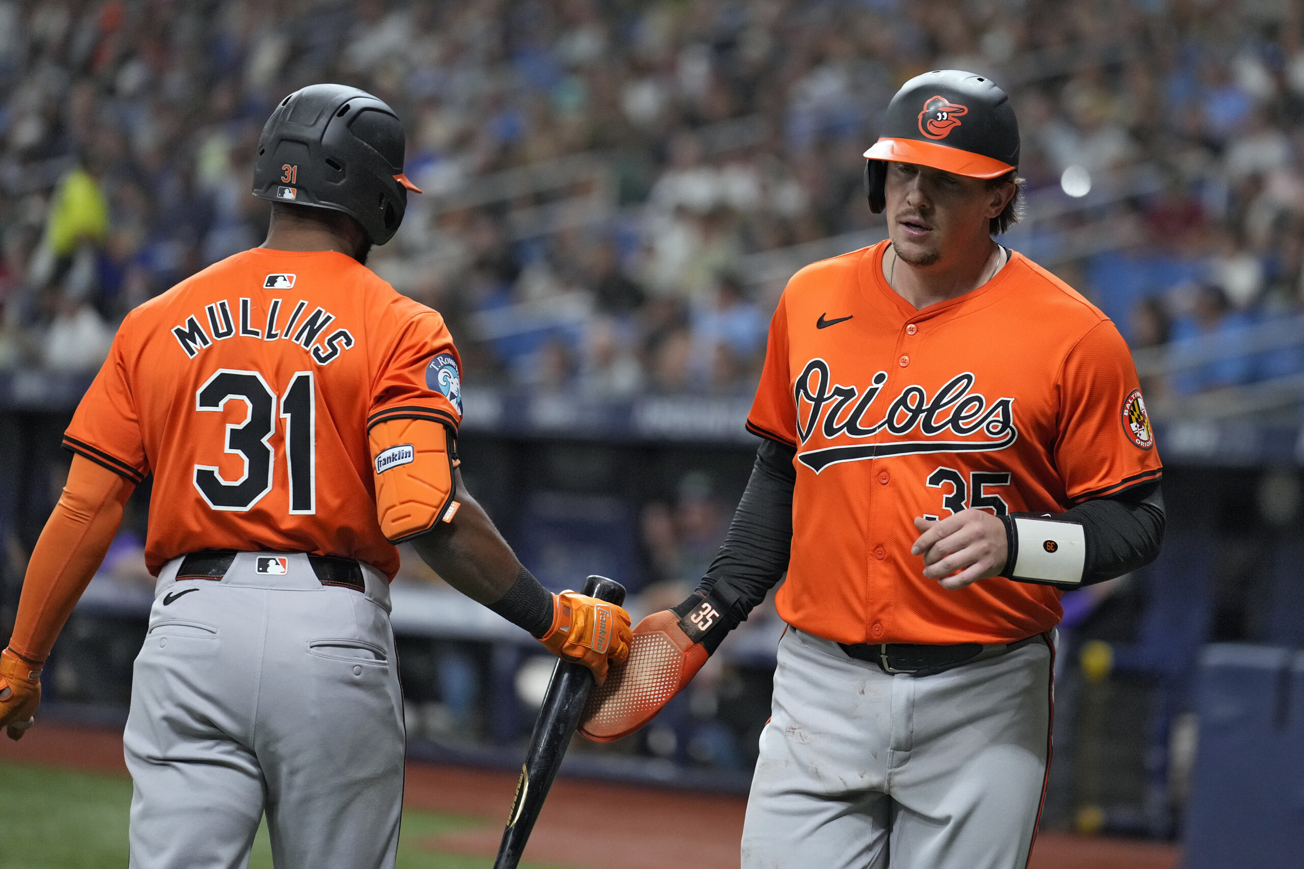 Baltimore Orioles' Adley Rutschman (35) celebrates with Cedric Mullins (31)...