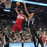 Nov 13, 2024; San Antonio, Texas, USA; Washington Wizards forward Alex Sarr (20) goes up to dunk while defended by San Antonio Spurs center Victor Wembanyama (1) during the second half at Frost Bank Center. Mandatory Credit: Scott Wachter-Imagn Images