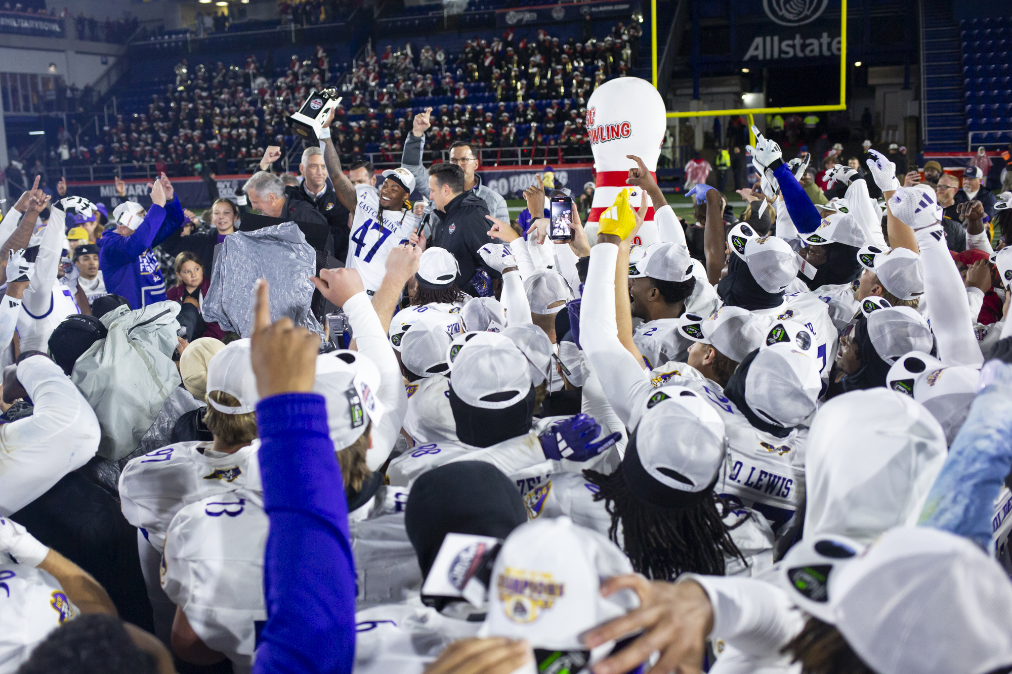 East Carolina’s Rahjai Harris holds up the trophy to celebrate...