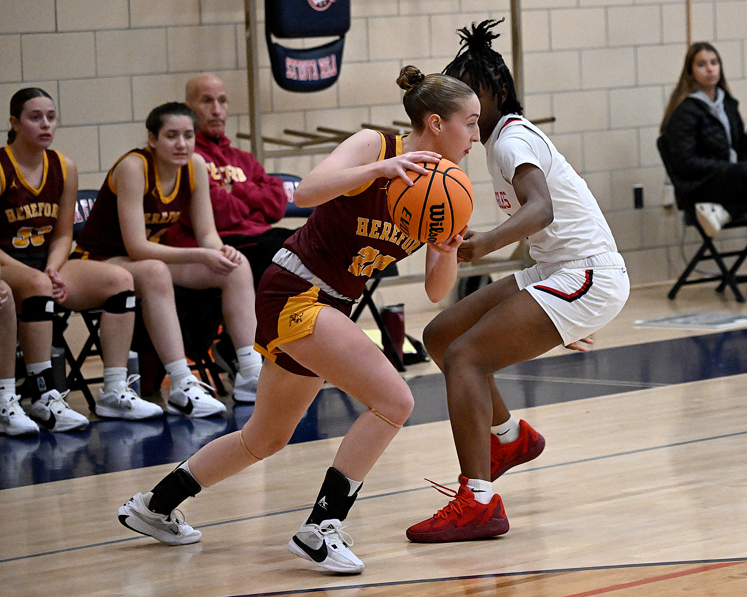 Hereford #20, Anna Orner breaks a full-court press in the...