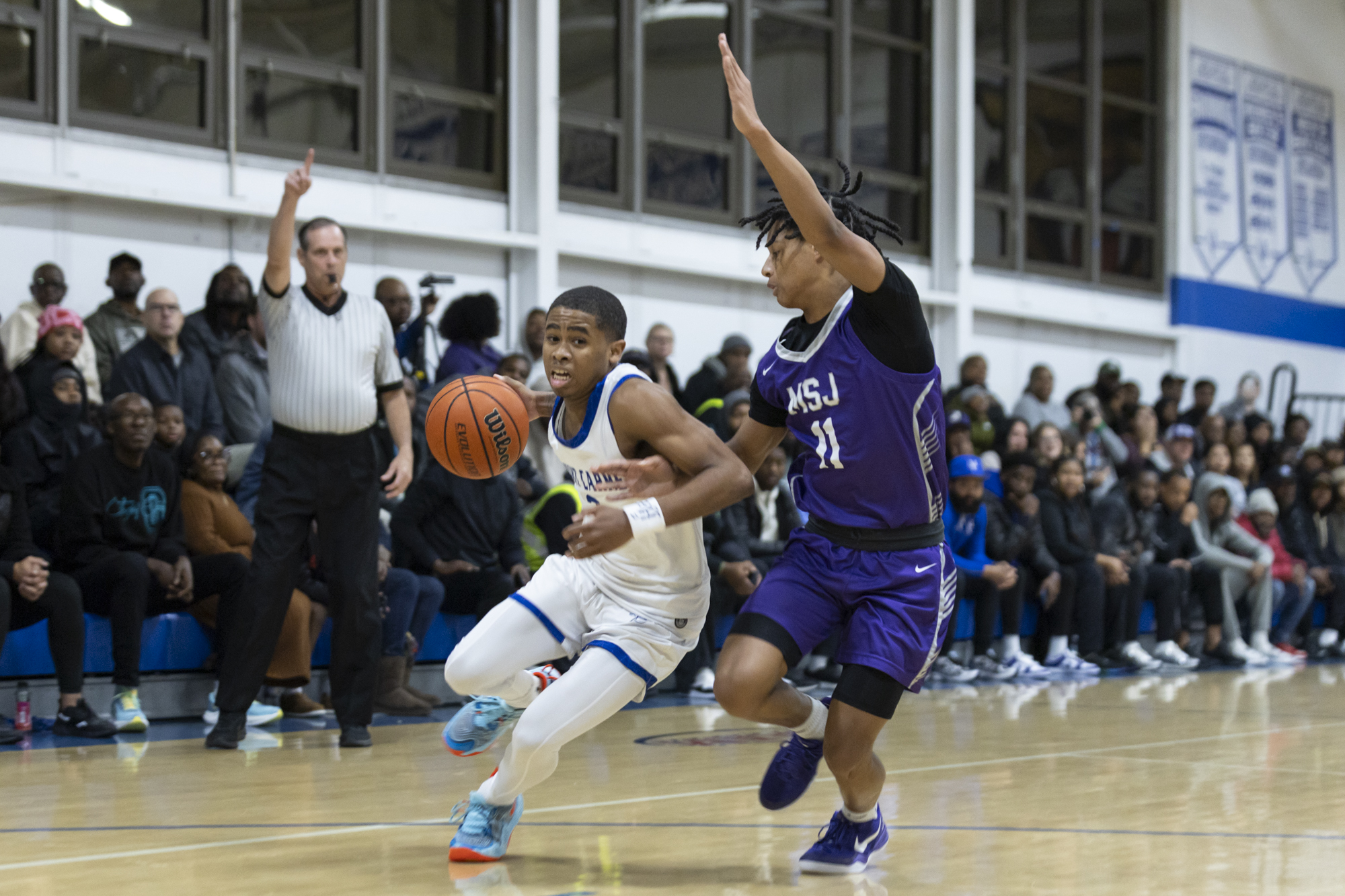 Mount Carmel's Rodney Scott drives past the defense of Mount...