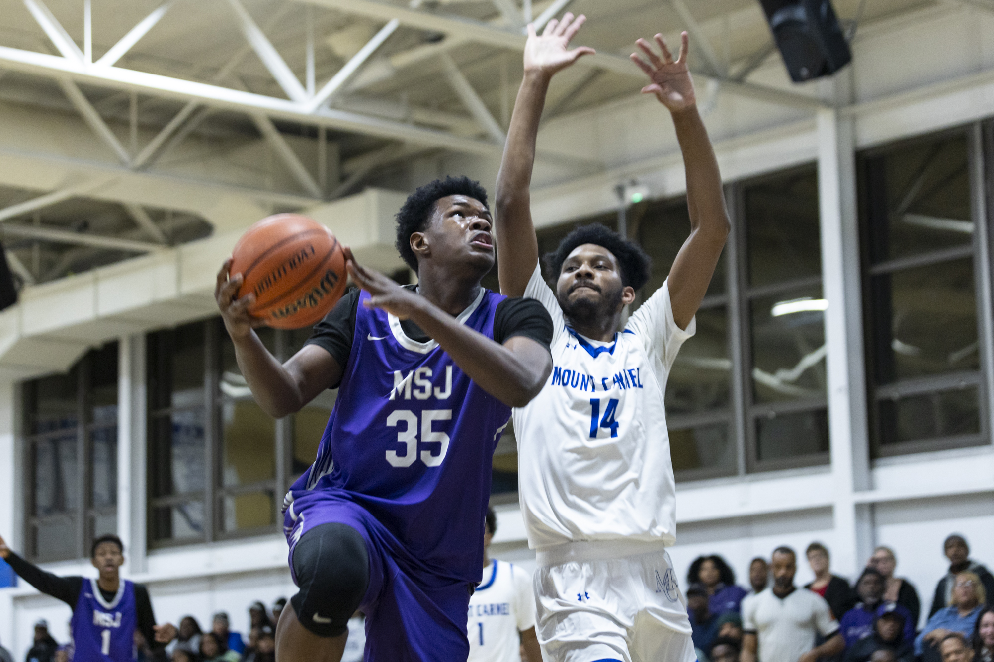 Kenneth Anthony puts up a shot against Tristan Heflin during...