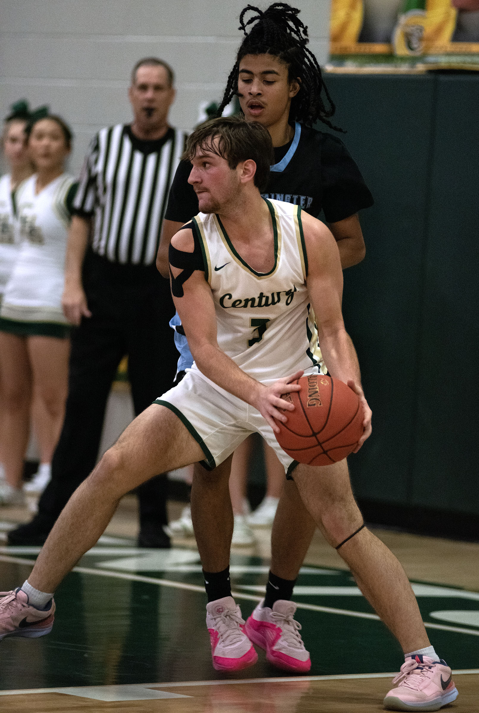 Jan. 14, 2025- Century's Braden Davis lands with a rebound...