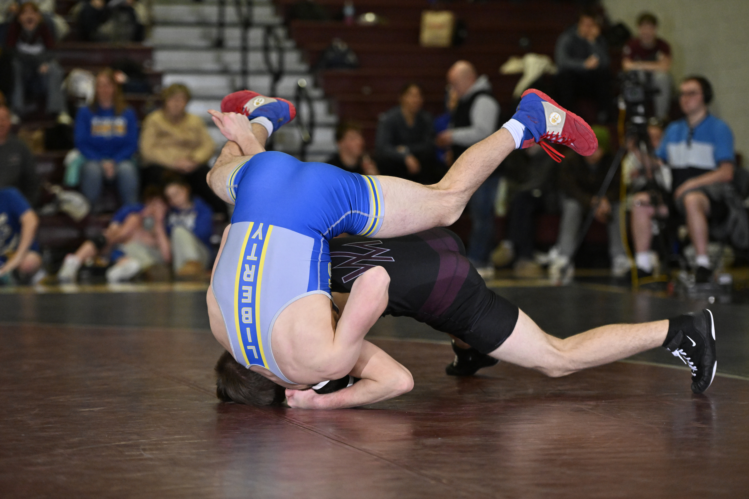 Liberty's Sam Paretta is flipped upside down by Winters Mill's...